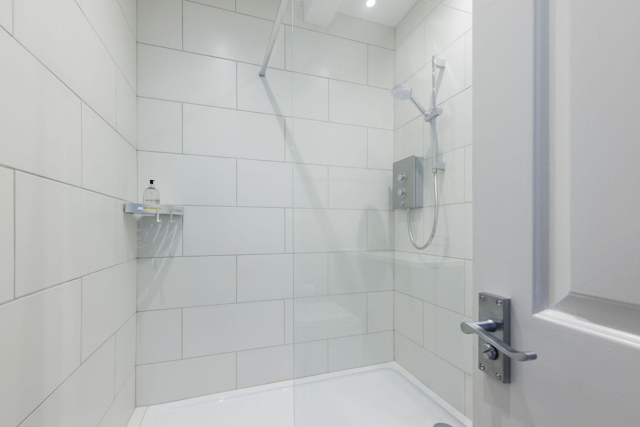 The bathroom has a large walk in shower, WC and sink.