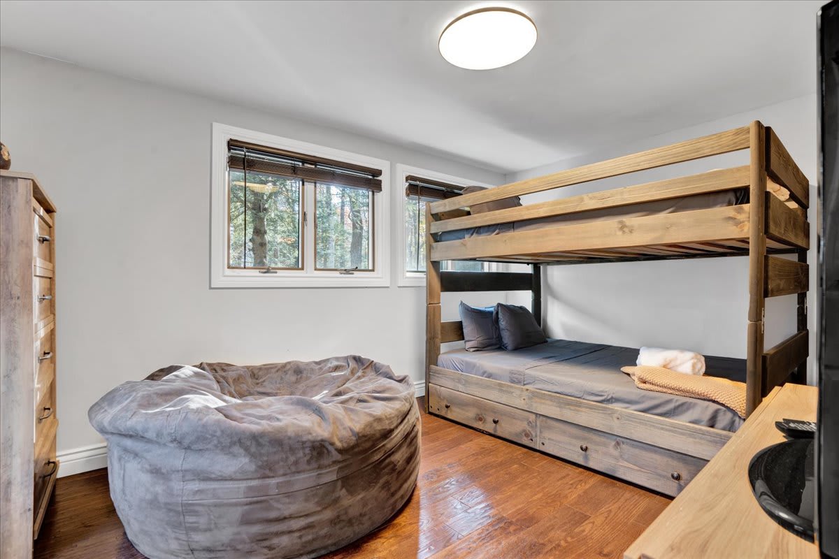 Features a sturdy bunk bed and a cozy bean bag, making it a great space for kids or extra guests.