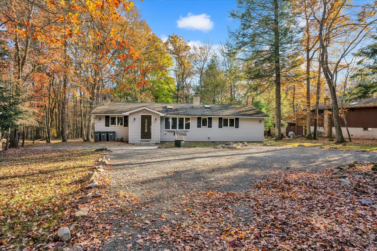 Arriving is a breeze with ample parking and a welcoming entrance surrounded by stunning autumn foliage, your retreat starts the moment you pull in.