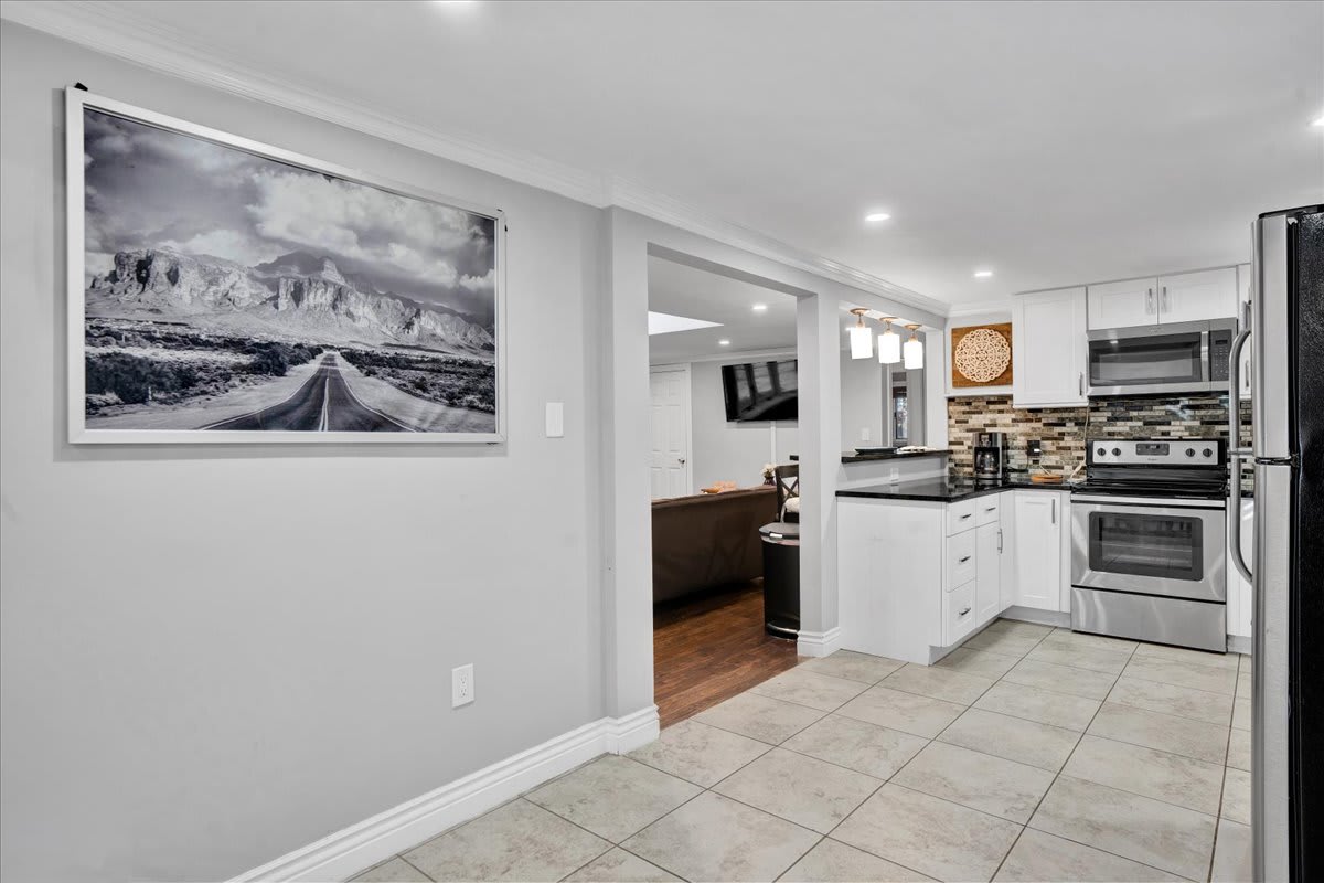 Seamless Flow from Kitchen to Living Area
An open layout makes this space feel bright and connected. A beautiful accent wall and thoughtfully placed décor add a touch of elegance, making every step through the home feel inviting.