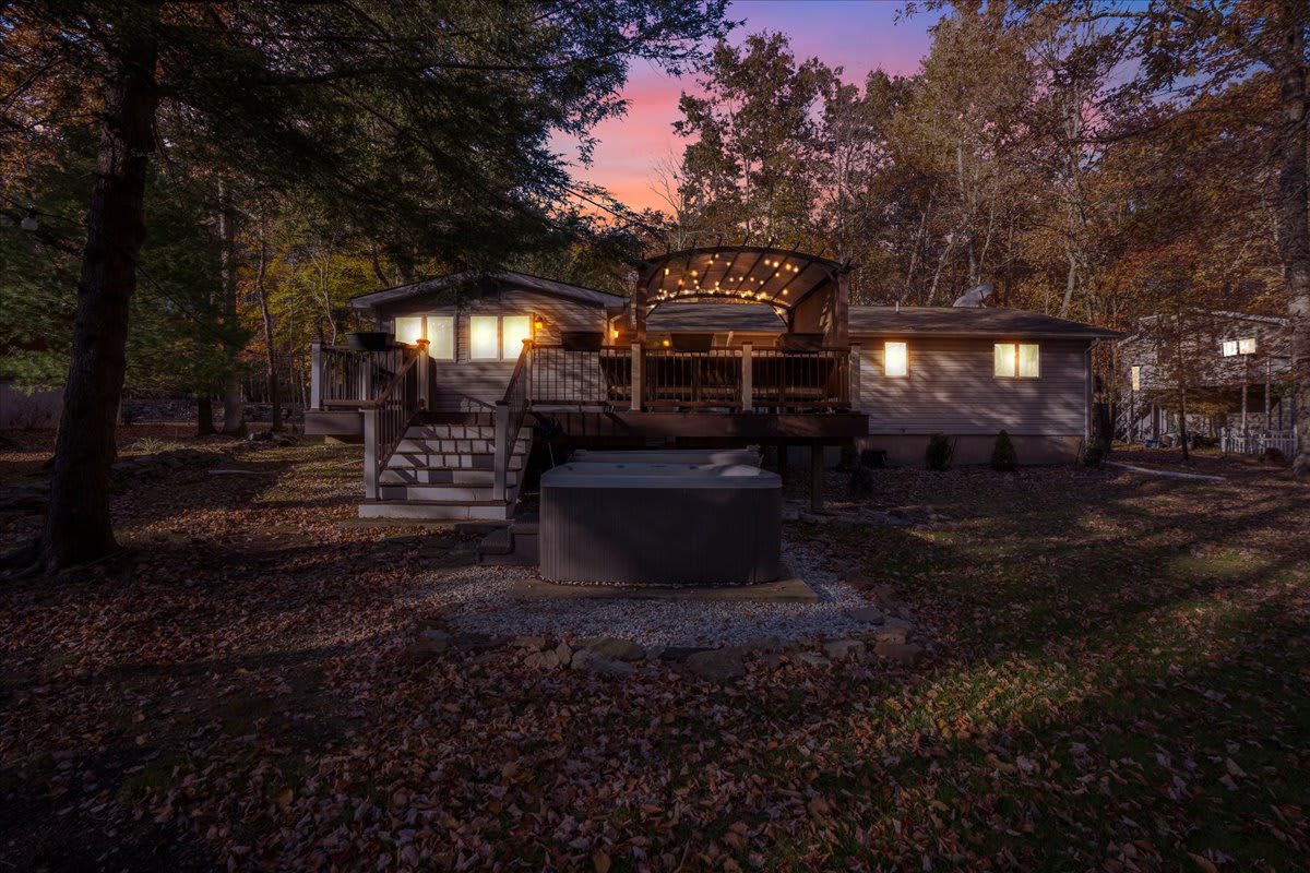 Cozy Evenings Under the Stars
The backyard transforms into a magical nighttime oasis, complete with ambient lighting, a charming deck, and a hot tub ready for relaxation. Unwind, soak, and let the peaceful surroundings melt the day away.