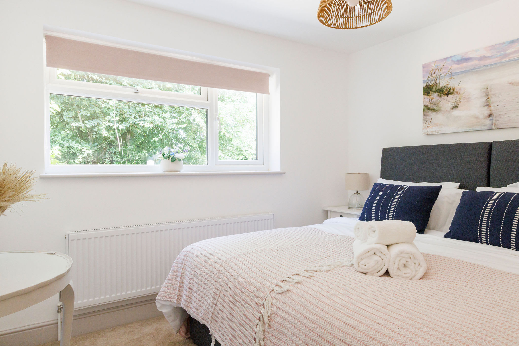 Rest easy in our cozy bedroom with a serene view and plush linens