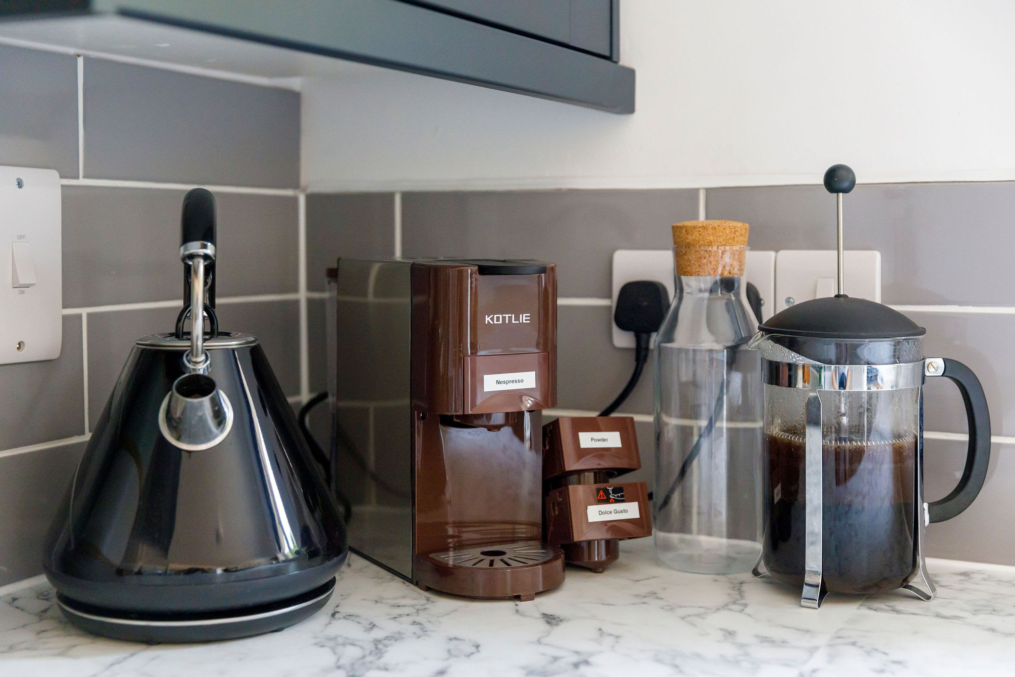 Start your day right with our well-equipped coffee station featuring a French press and coffee machine