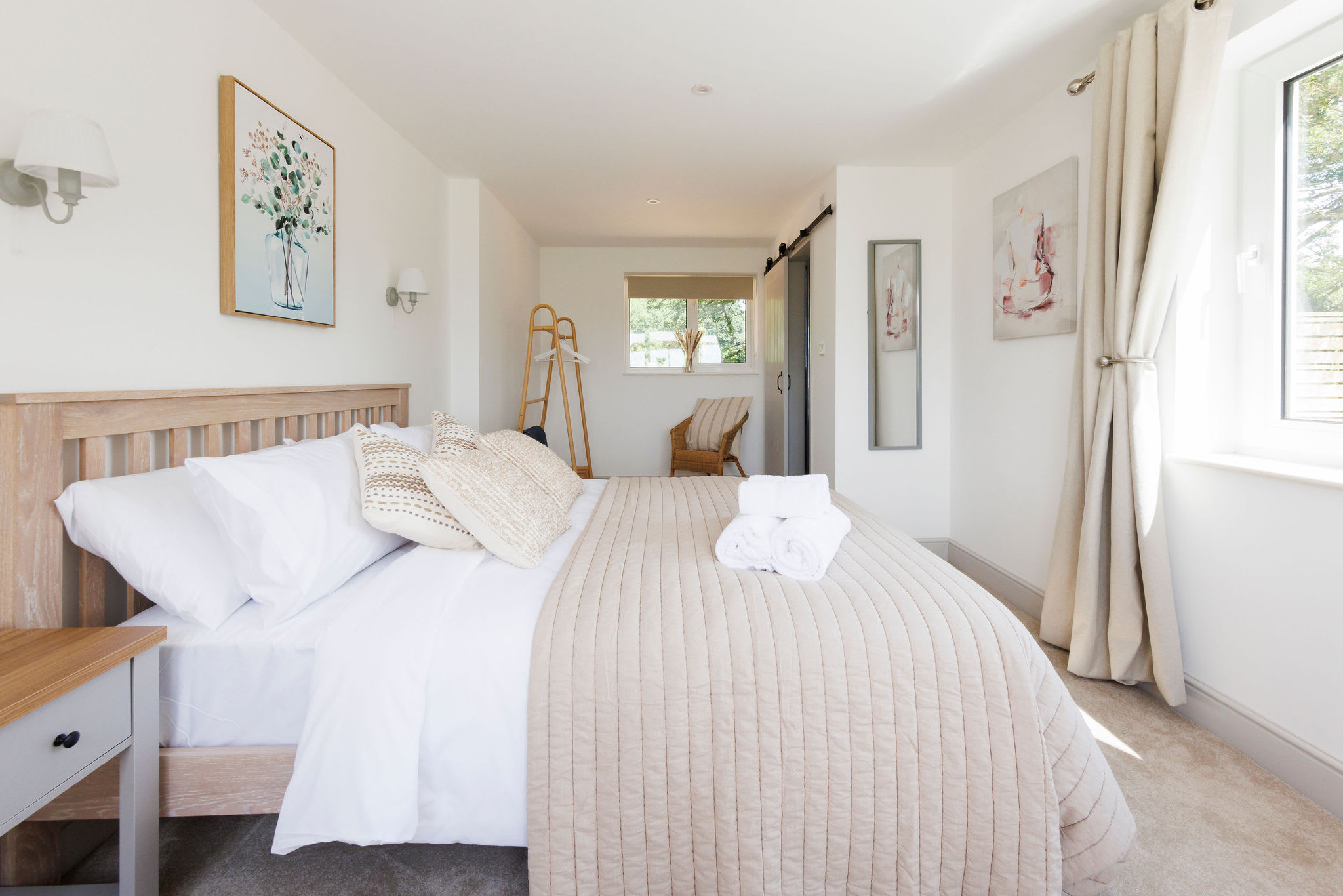 Elegant master bedroom with soft, inviting linens and rustic charm