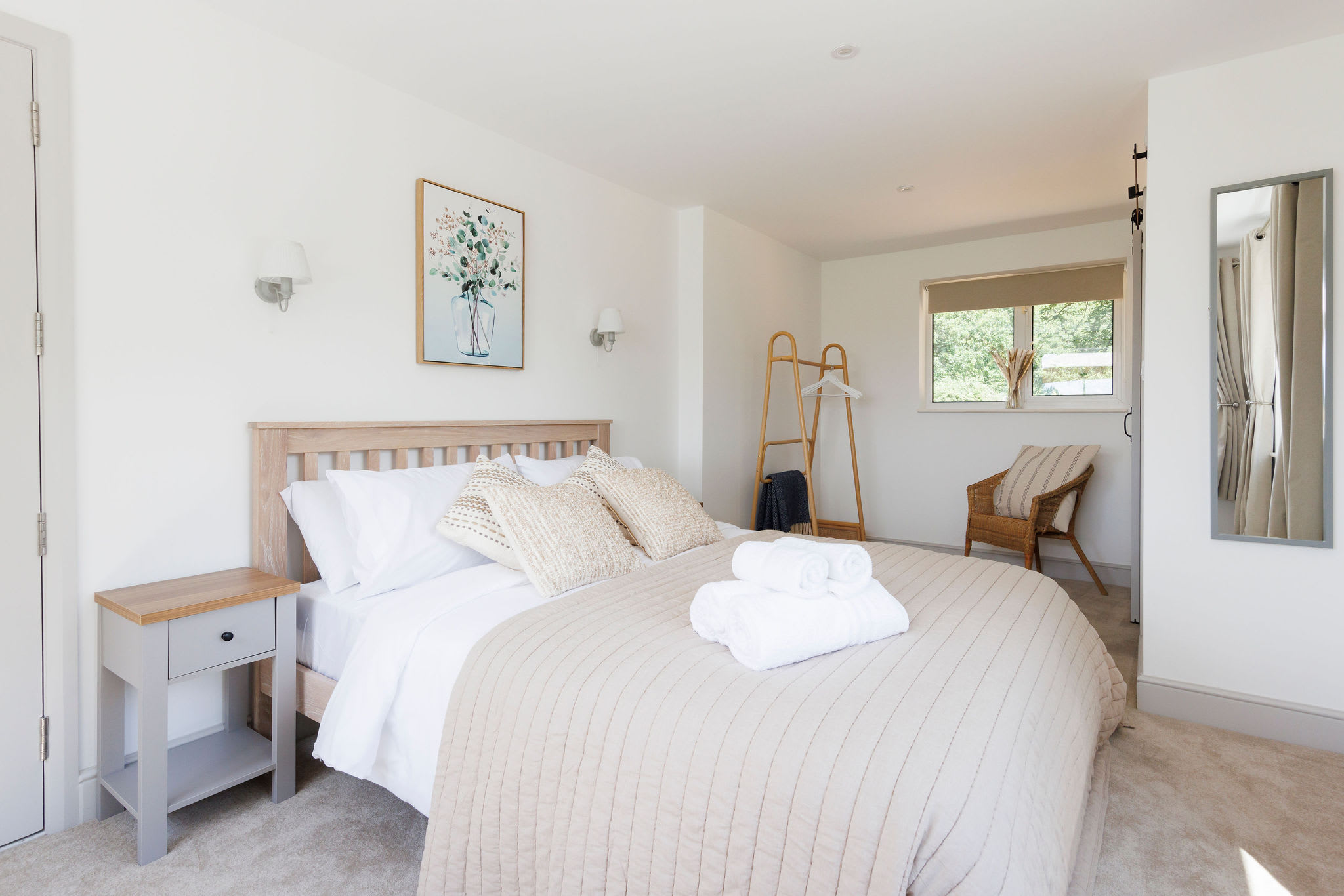 Spacious master bedroom with neutral tones and plenty of natural light