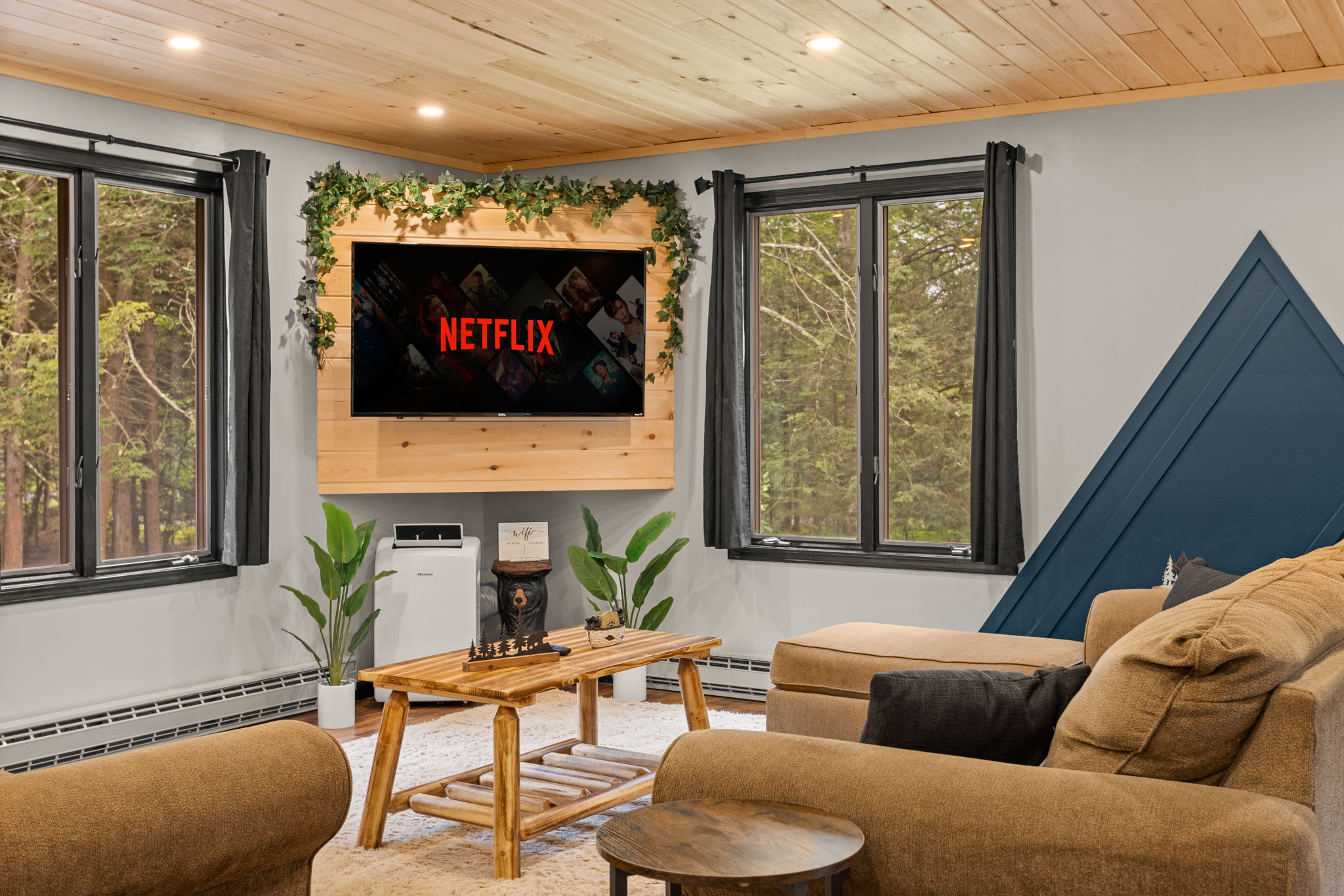 Cozy & Stylish Entertainment Lounge – A perfect gathering space with a plush sectional, rustic decor, and a Netflix-ready setup for movie nights in the mountains.