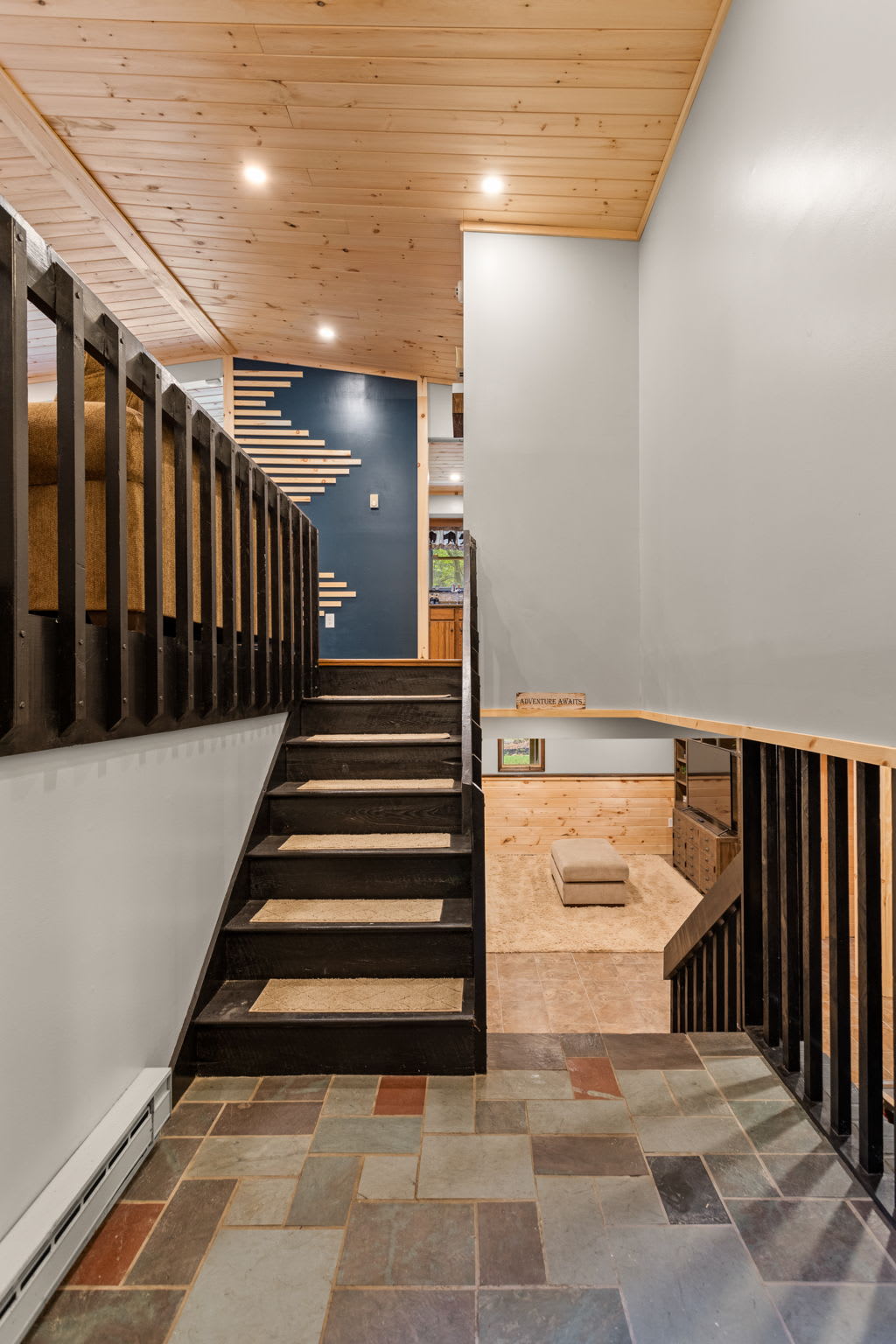 Sleek Stairway Design – A bright and modern hallway leading to the main living areas, featuring wood and metal accents for a contemporary touch.