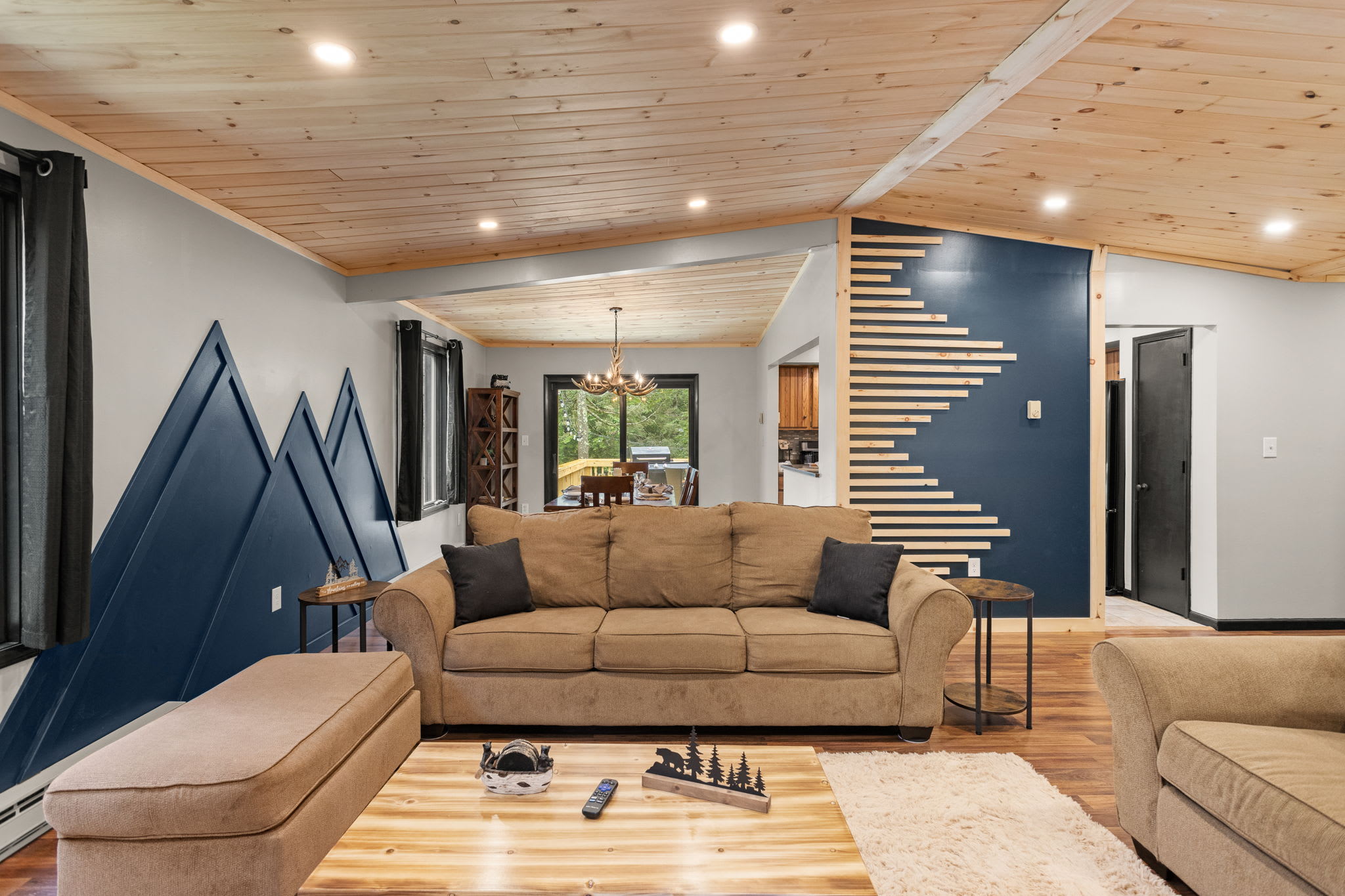 Rustic Meets Contemporary Charm – A cozy lounge with earthy tones, bold accent walls, and a seamless open-concept layout for an inviting atmosphere.