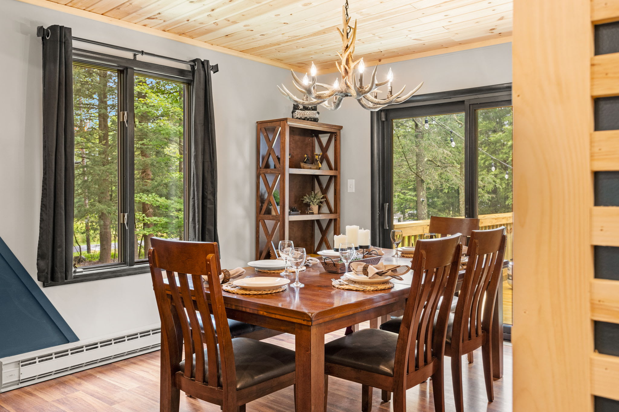 Elegant & Cozy Dining Area – A warm and inviting dining space with rich wood furniture, natural light, and a classic chandelier to create a timeless ambiance.