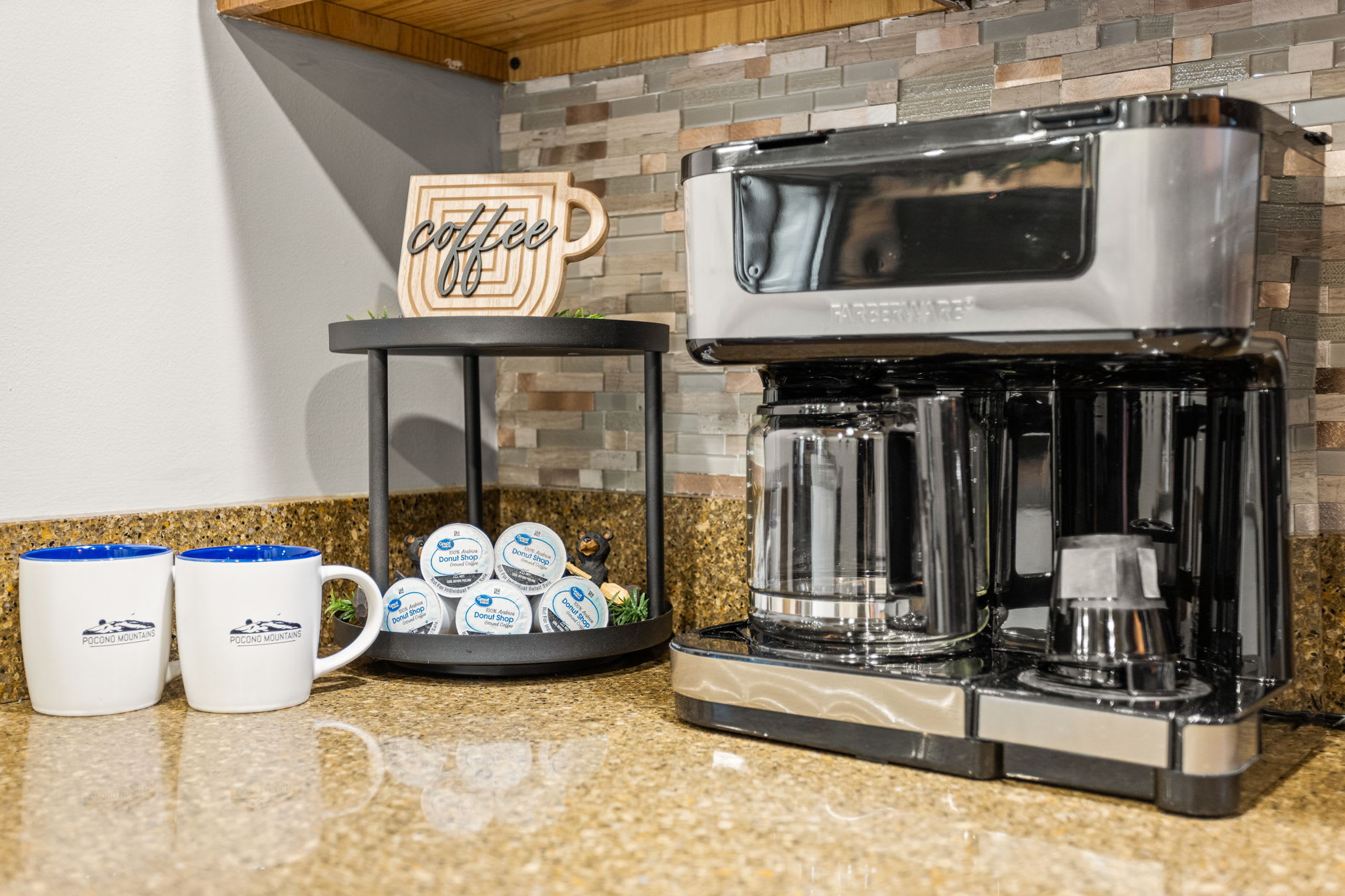 A cozy coffee nook with a modern drip coffee maker, stylish mugs, and a rustic "Coffee Time" sign to start your mornings right.