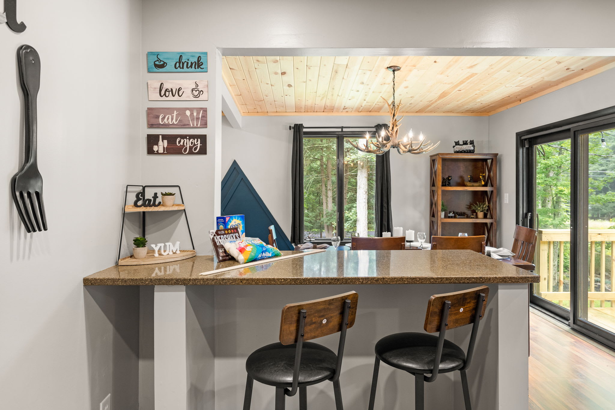 Inviting Breakfast Bar – A stylish kitchen island with high-top seating, natural light, and a perfect blend of modern and rustic elements.