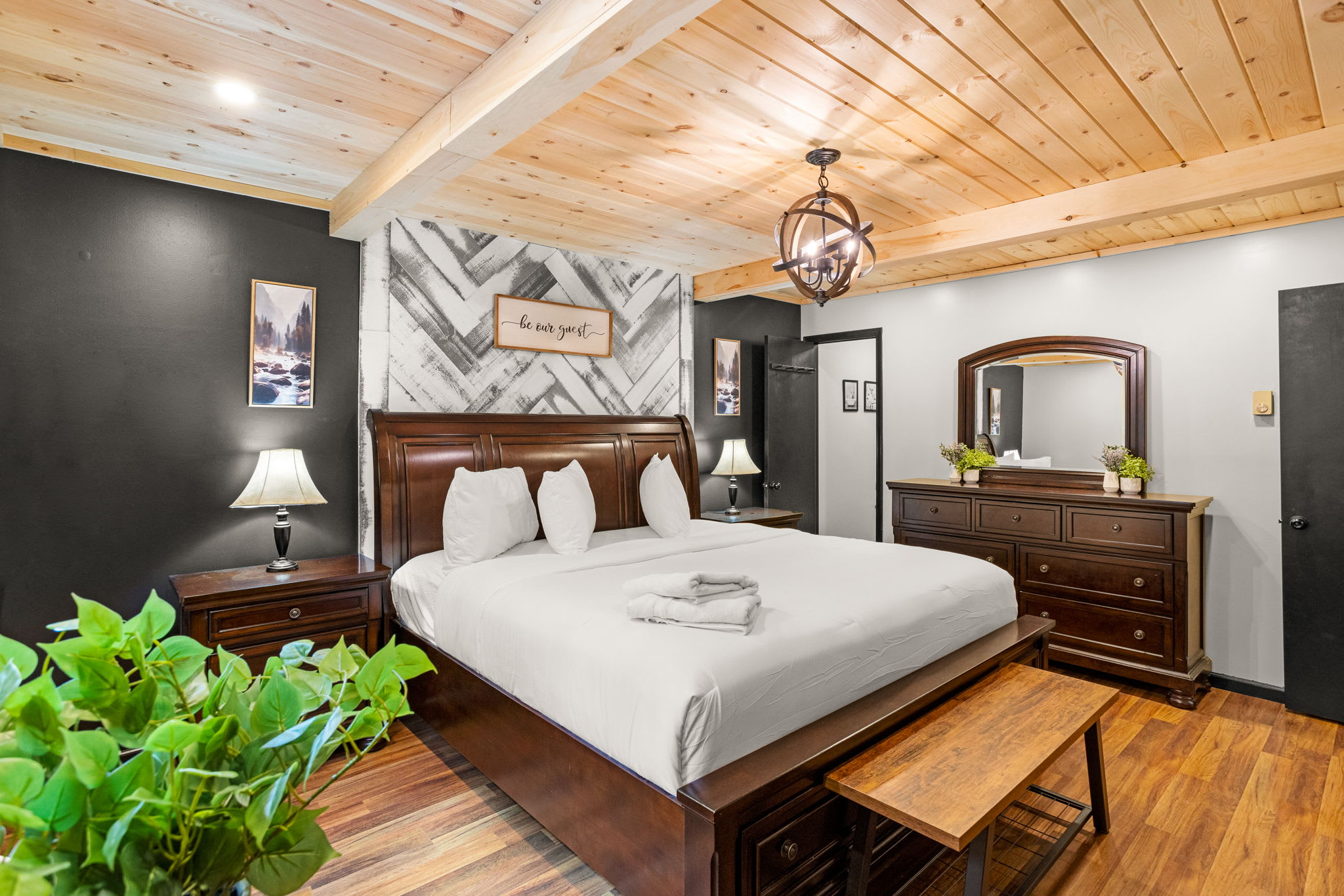 Rustic Charm Meets Modern Comfort – A spacious and inviting bedroom with classic wooden furniture, soft lighting, and stylish decor for ultimate relaxation.