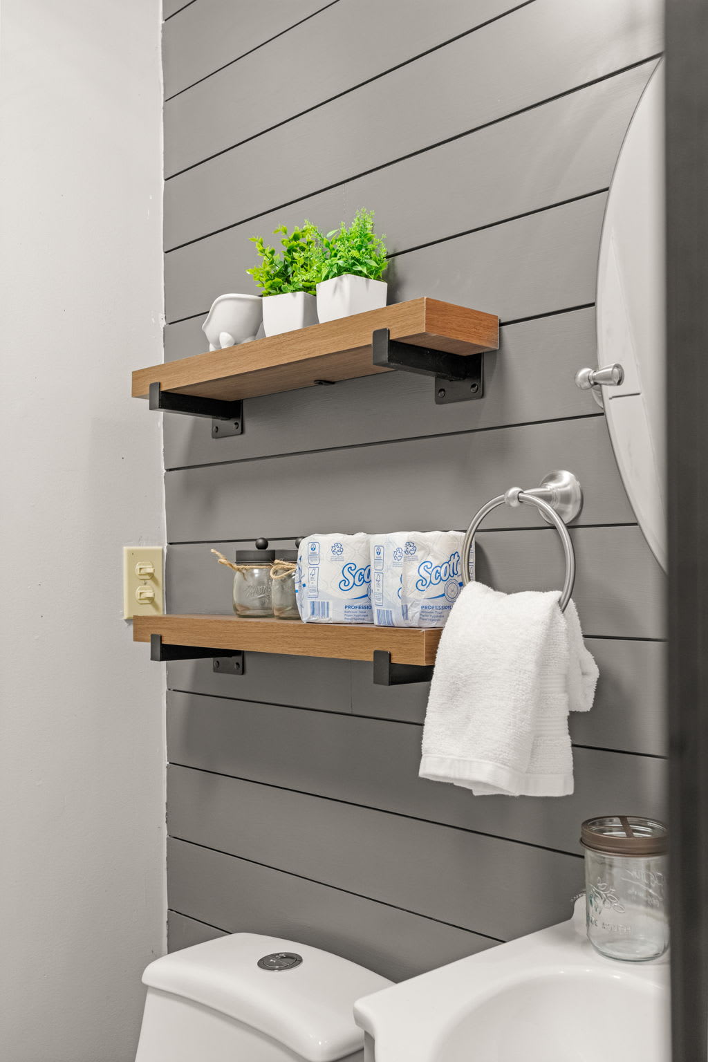 Charming Bathroom Storage – Thoughtfully designed wall shelves add a touch of rustic charm while keeping essentials neatly organized.
