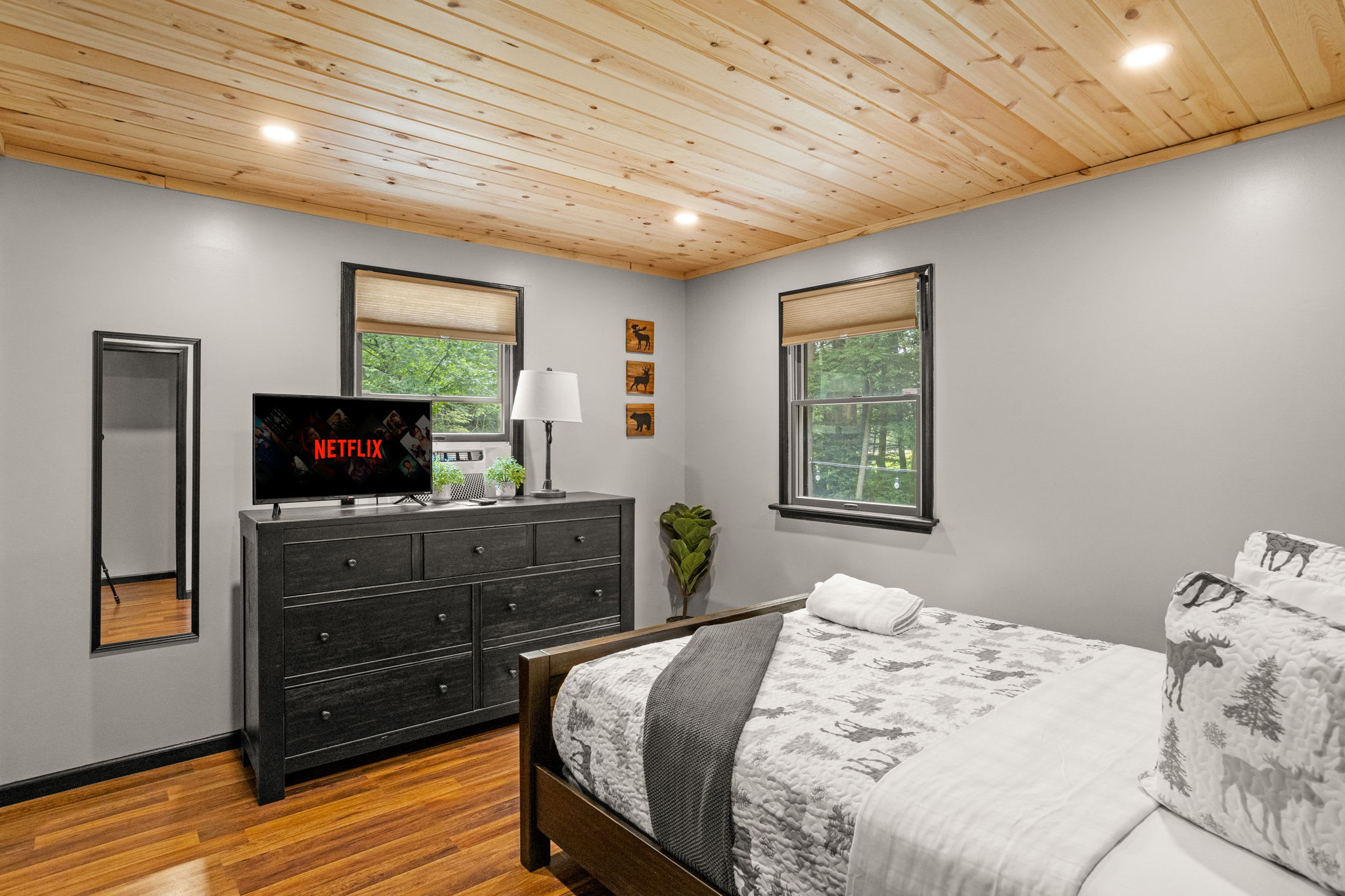 A bright and airy bedroom with a mix of modern and rustic decor, creating a peaceful and inviting atmosphere.