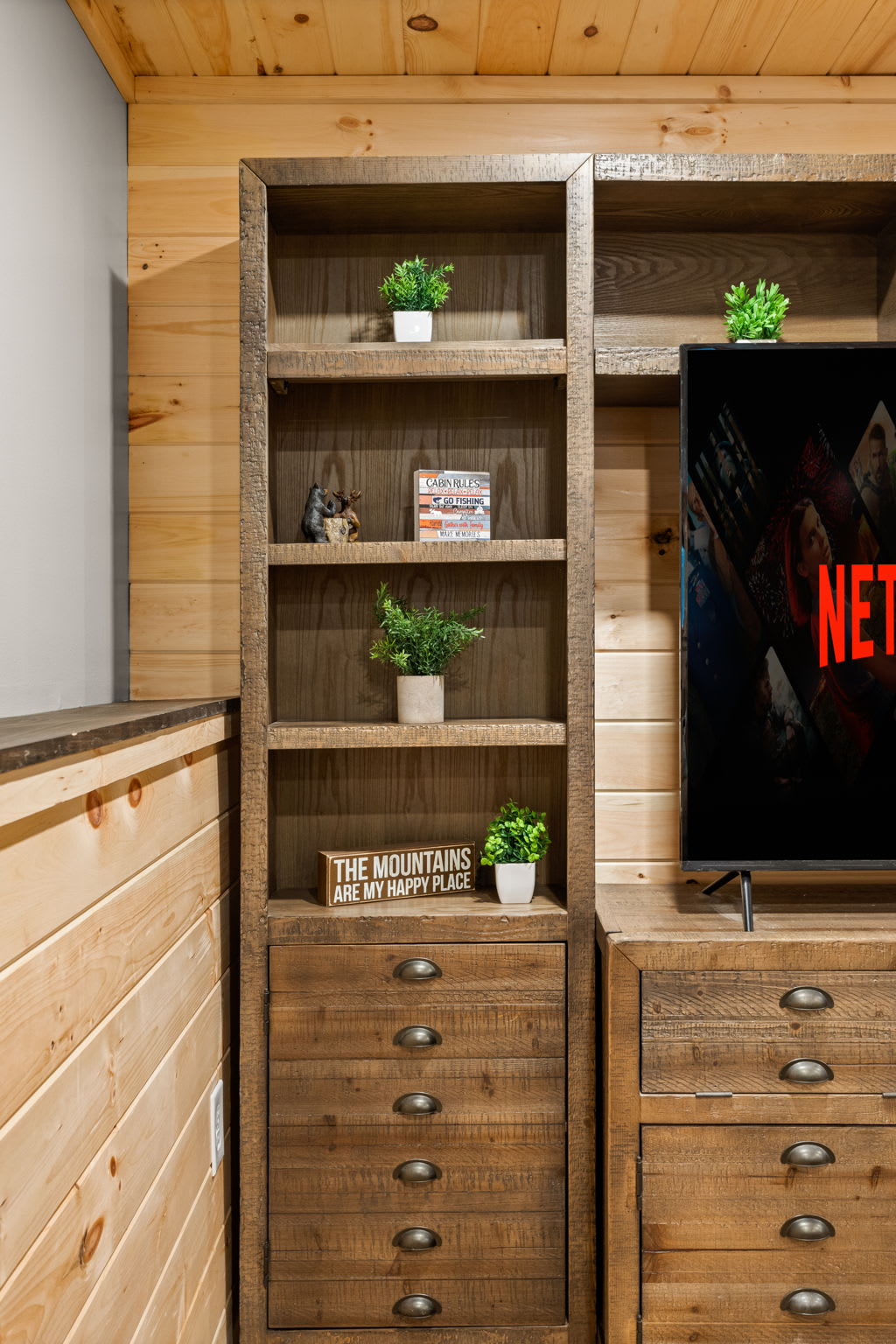 Custom Built-In Entertainment Center – A stylish and functional shelving unit surrounding the TV, offering both storage and a rustic-chic aesthetic.