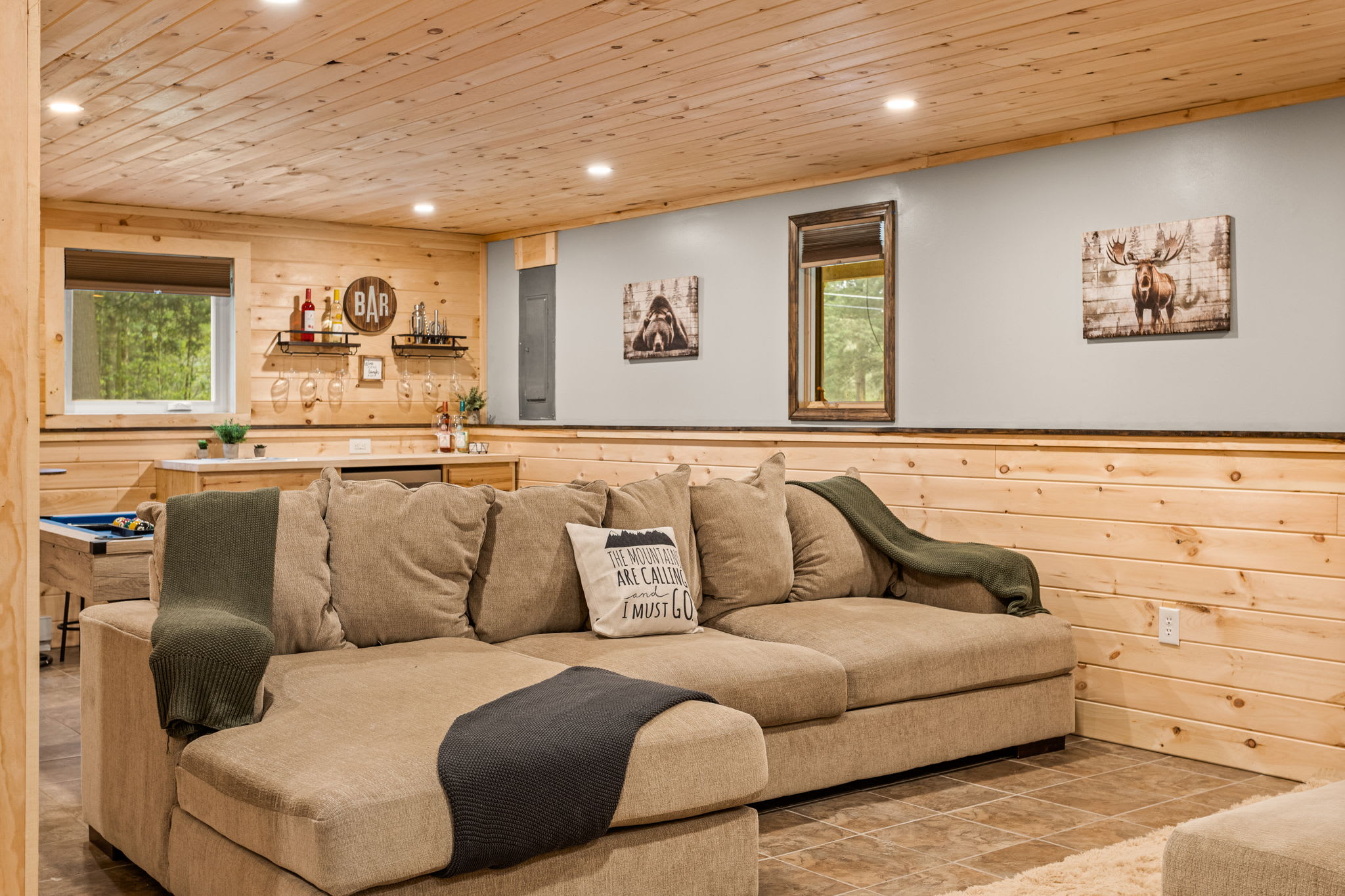 A warm and inviting living space with a plush sectional, decorative accents, and a perfect blend of modern and rustic charm.