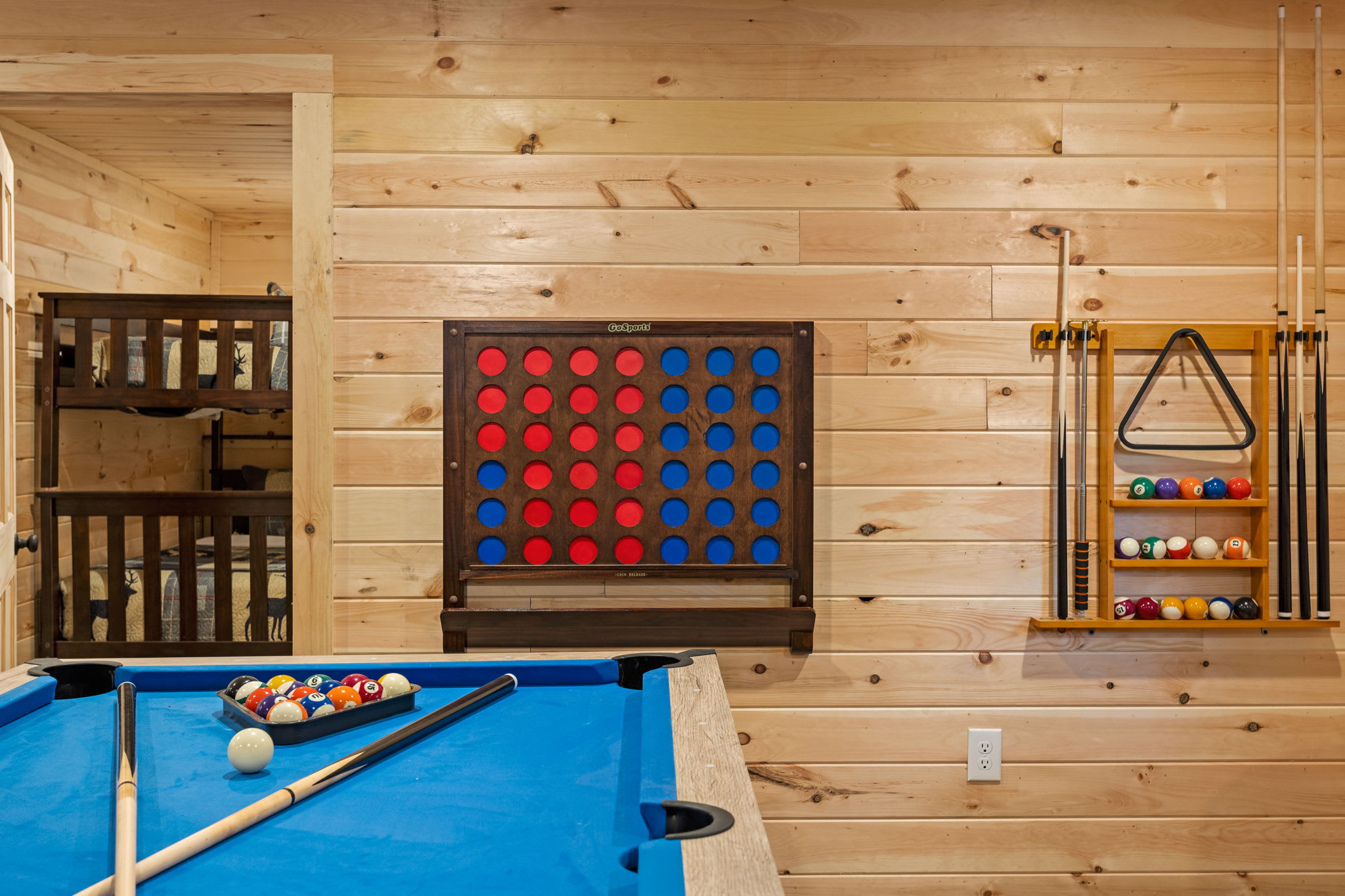 The Ultimate Game Night Spot – A cozy and inviting game room equipped with a pool table, bar seating, and fun interactive wall games for all ages.
