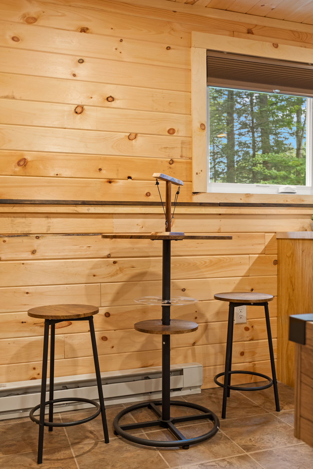 Cozy Bar Seating Nook – A charming and compact bar area with high-top stools, perfect for enjoying drinks while overlooking the serene outdoor views.