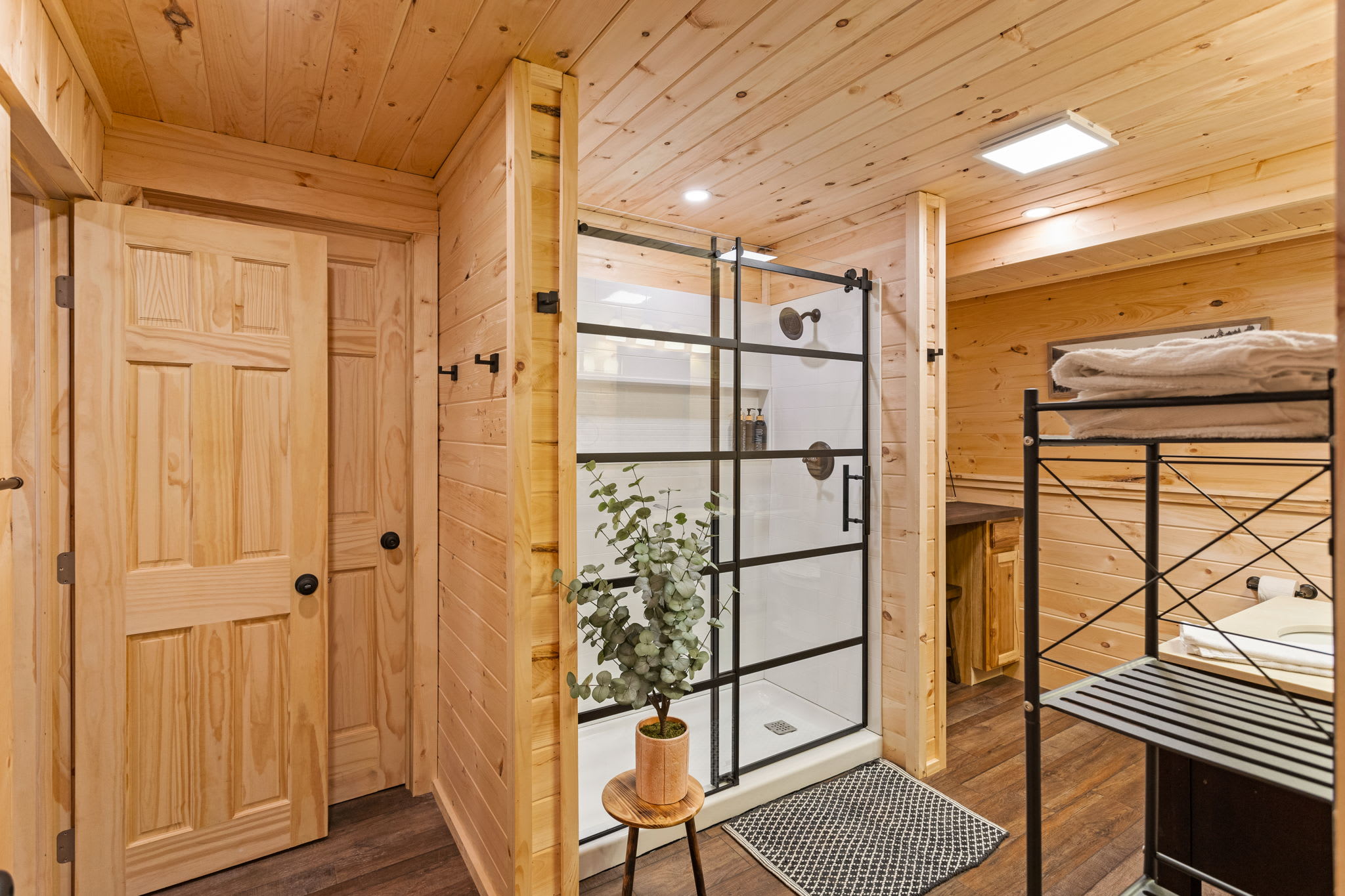  A stylish and inviting bathroom with wooden walls, ample storage, and a cozy yet refined aesthetic.
