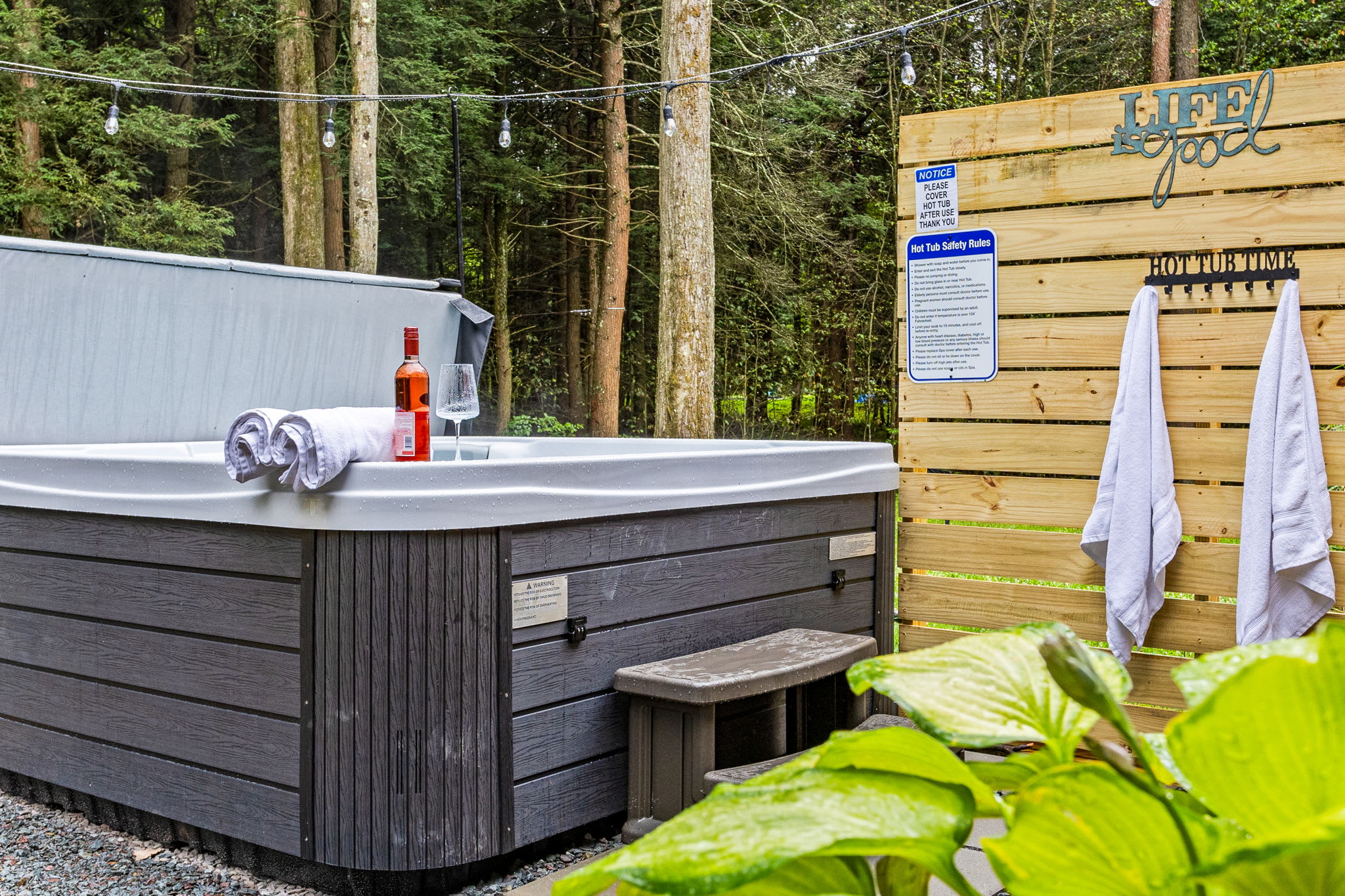 A beautifully designed outdoor hot tub area, complete with modern amenities and surrounded by nature for a tranquil retreat.