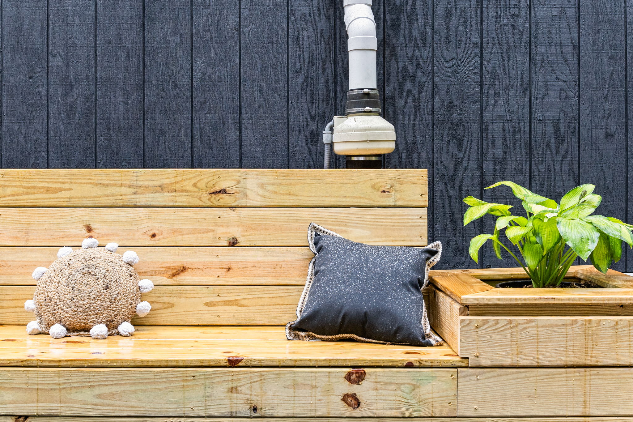 A thoughtfully designed seating area with natural wood finishes and cozy decor, ideal for unwinding in the fresh air.