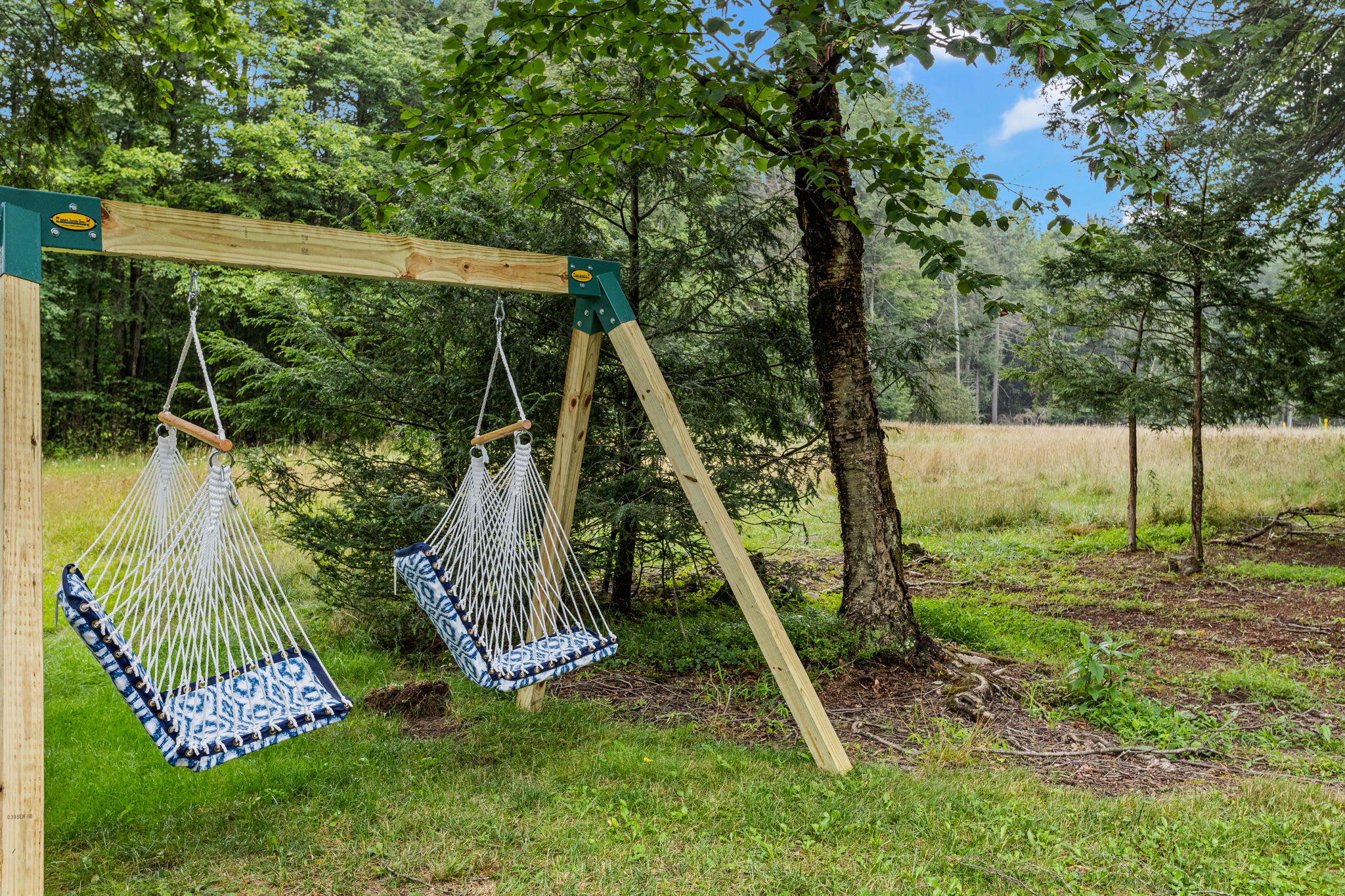 Relaxing Outdoor Swing Nook – A peaceful woodland retreat featuring cozy hanging swings under the trees, ideal for unwinding and soaking in nature.