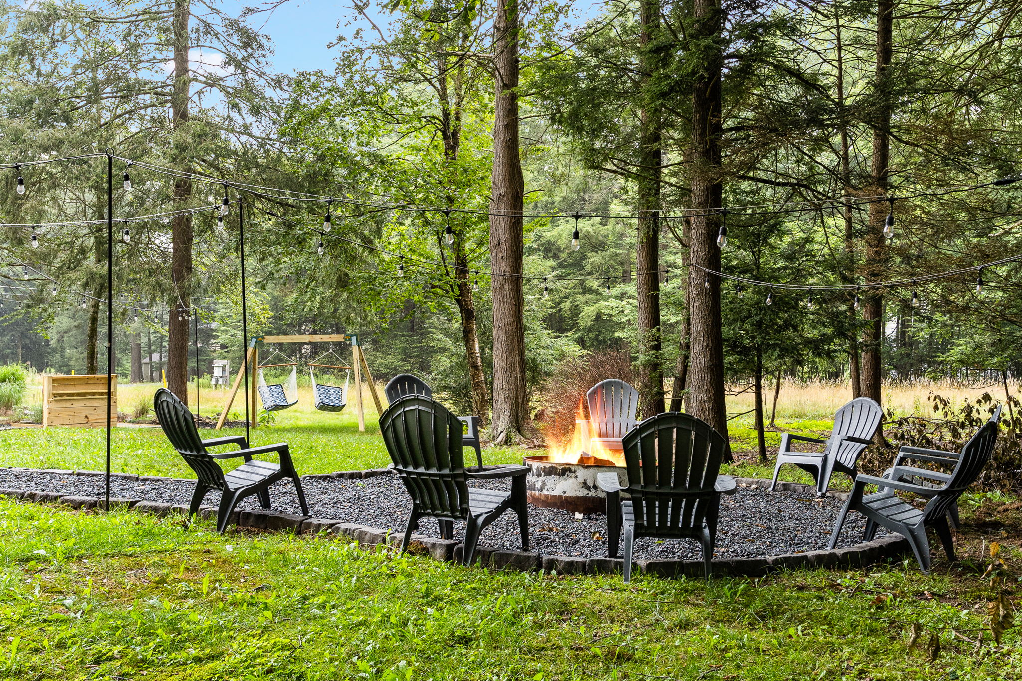 Cozy Fire Pit Gathering Spot – A charming outdoor fire pit area surrounded by Adirondack chairs, perfect for roasting marshmallows and enjoying the fresh air.