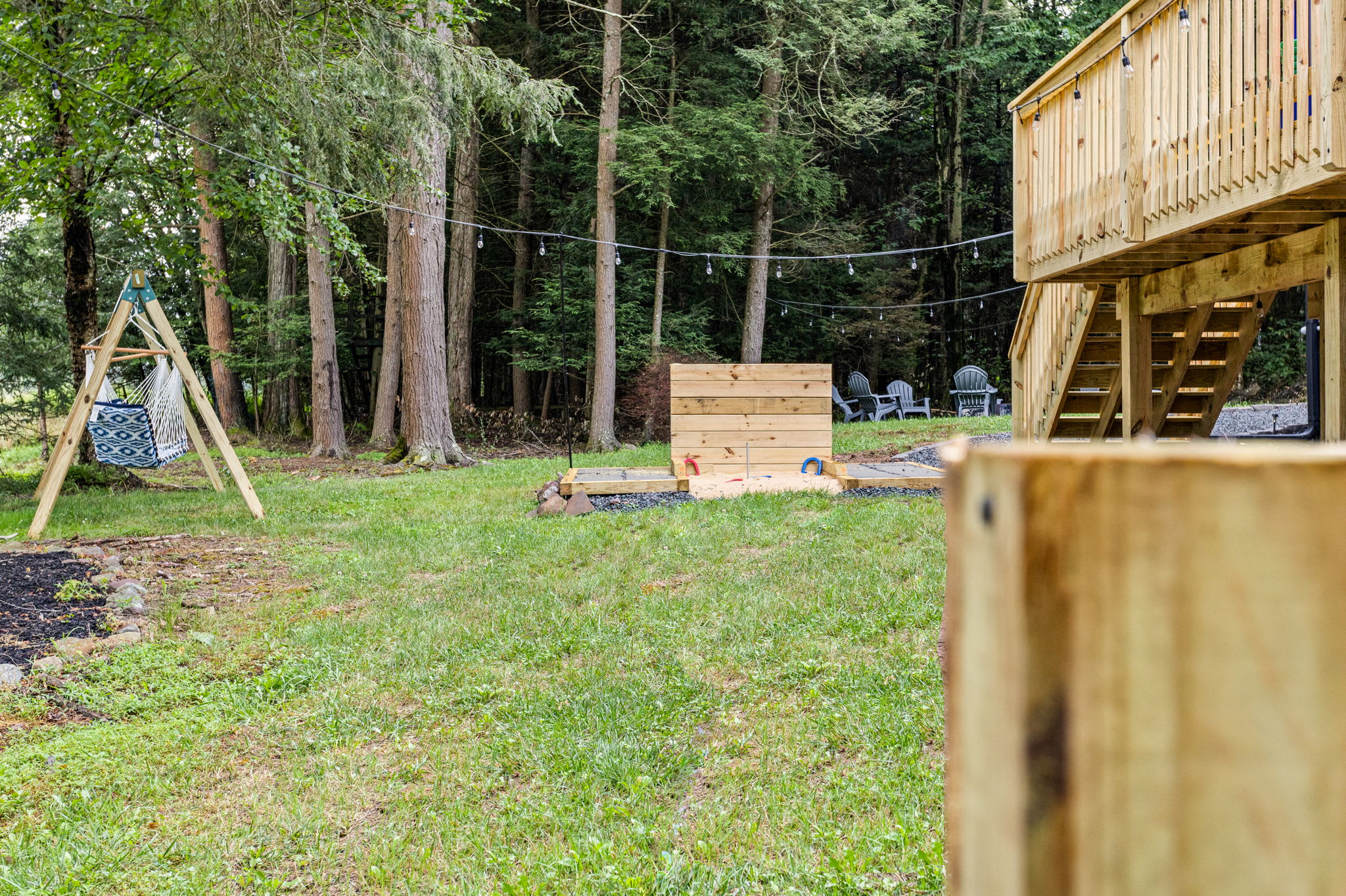 Backyard Game & Relaxation Zone – A spacious yard featuring a mix of outdoor games, fire pits, and seating areas, creating the perfect blend of fun and relaxation.