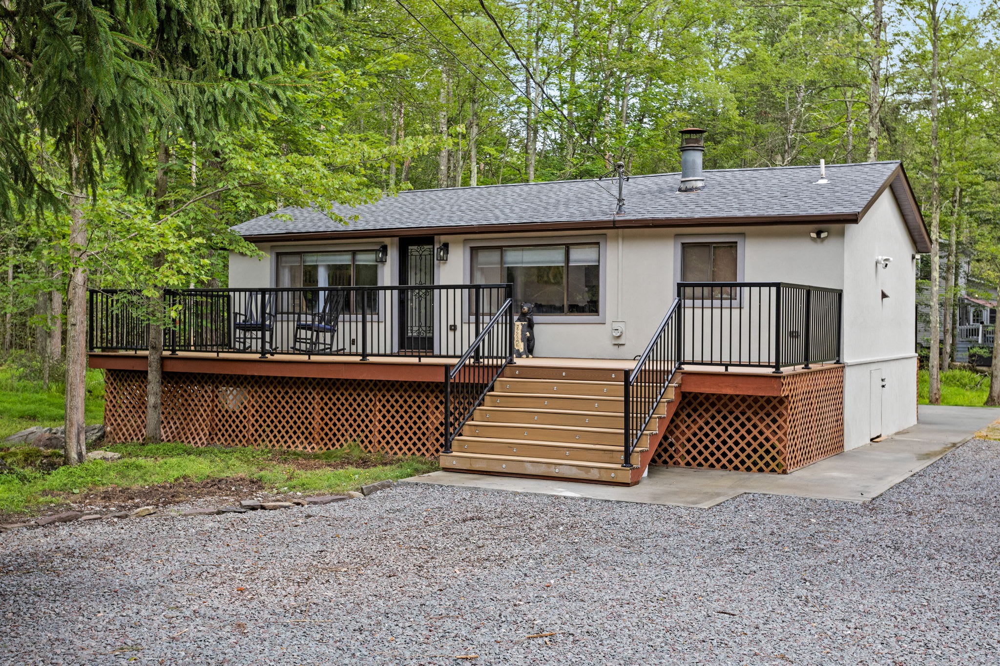 Nestled among tall trees, this beautifully updated home offers the perfect blend of modern comfort and nature’s tranquility. The spacious front deck is perfect for enjoying the fresh air and morning coffee.