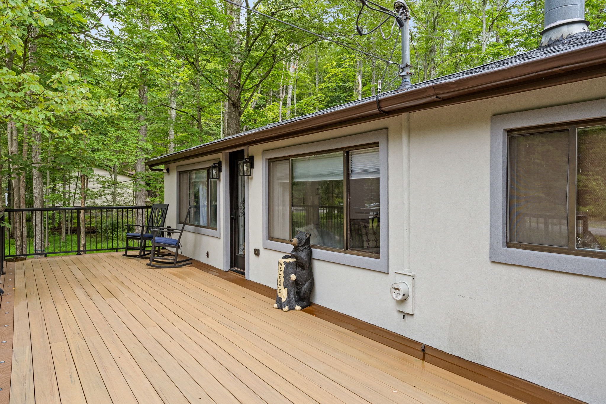 This spacious deck is perfect for outdoor lounging! Sip your morning coffee in the rocking chairs, take in the fresh forest air, or simply enjoy the quiet, scenic surroundings.