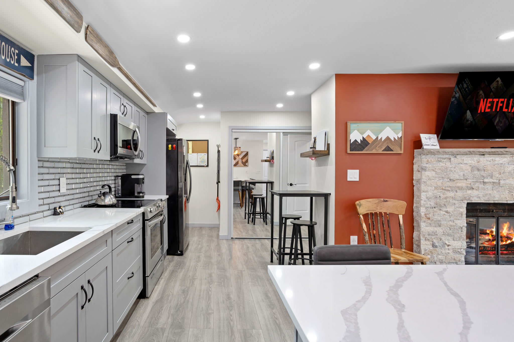 This thoughtfully designed kitchen flows seamlessly into the living space, offering a modern yet warm aesthetic with stylish accents and functional design.
