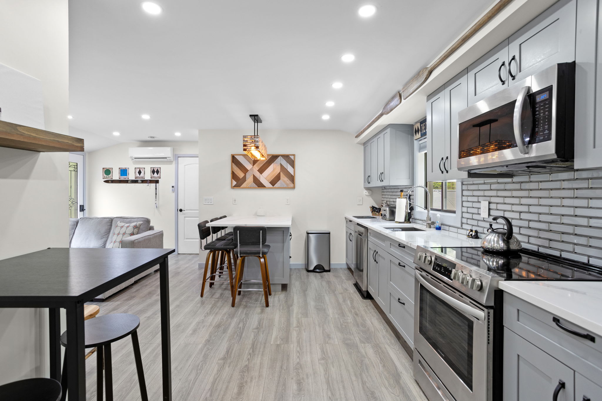 A well-lit, open kitchen with high-end appliances, elegant finishes, and a welcoming dining area, perfect for cooking, entertaining, or just enjoying a cozy meal.