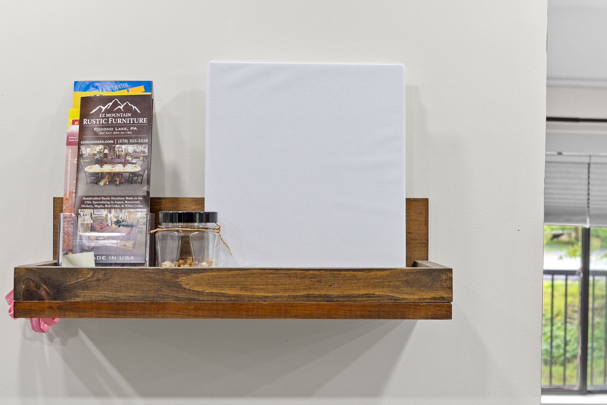 A handy shelf stocked with local brochures and a touch of rustic decor, ensuring guests have all the information they need to explore and enjoy their stay.