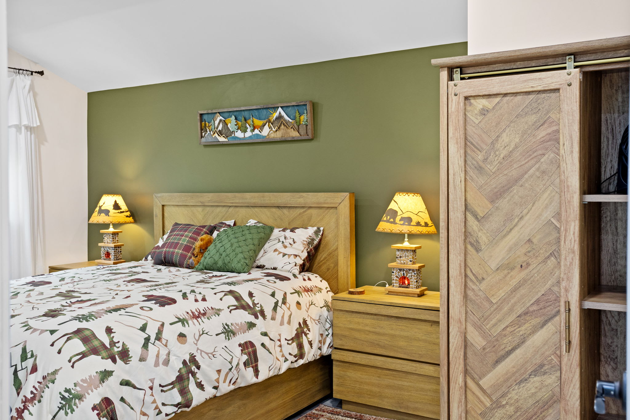 A cozy retreat with warm wood furnishings, earthy tones, and charming mountain-inspired decor. This room is designed for ultimate comfort and relaxation.