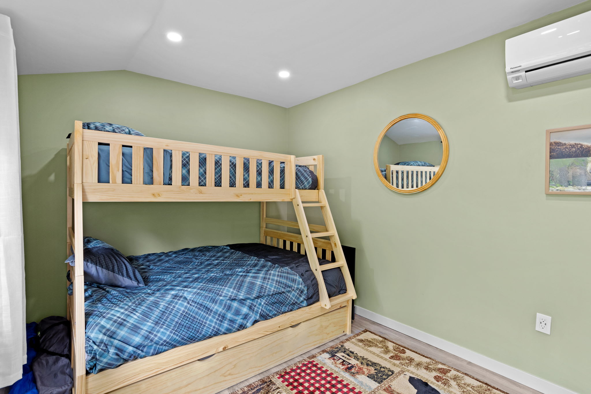 A perfect blend of style and function, this bunk room features a fresh, calming color palette, cozy bedding, and thoughtful rustic details.