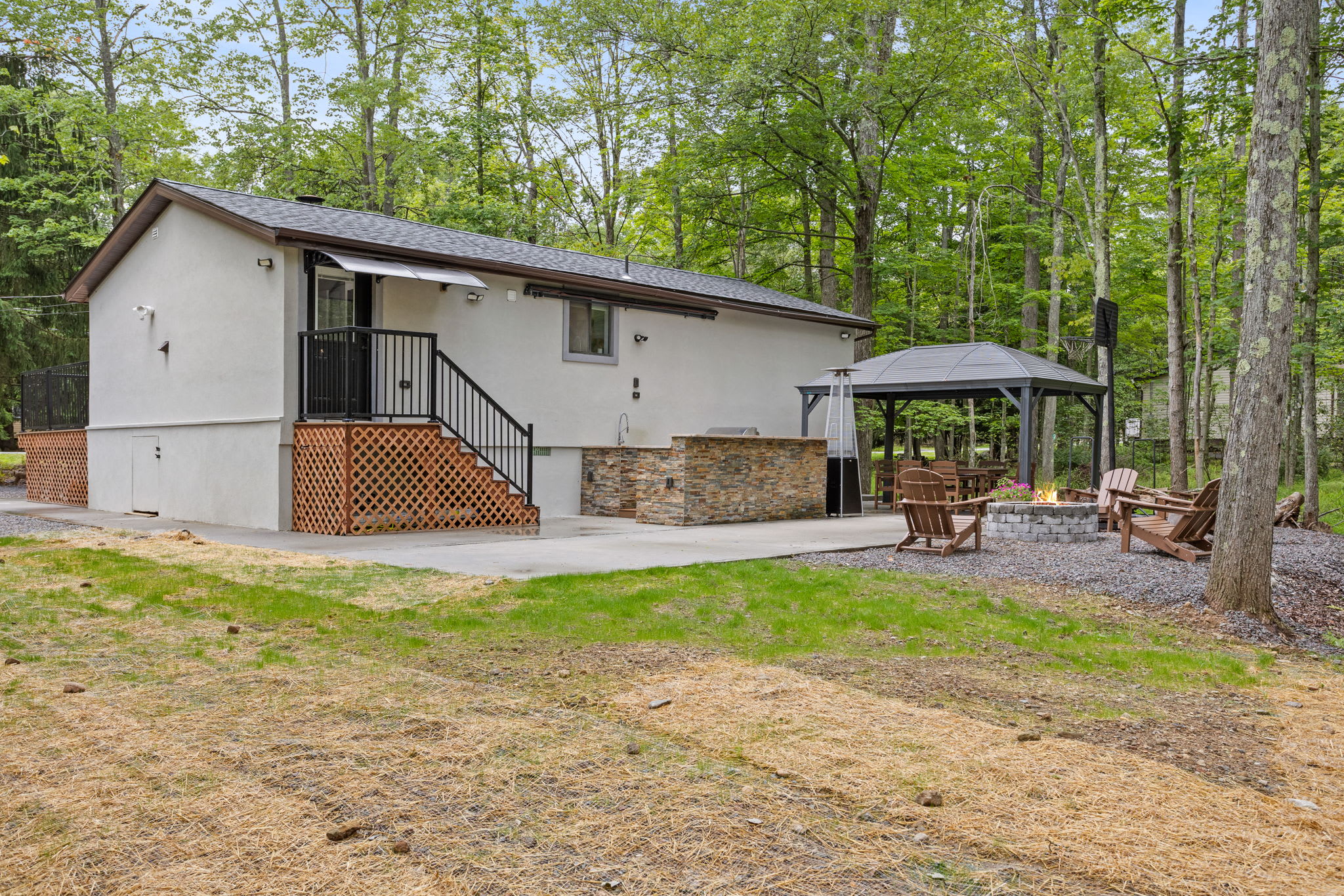 Nestled among towering trees, this private cabin offers the best of indoor-outdoor living with a beautiful patio, a covered dining area, and a firepit for cozy nights.