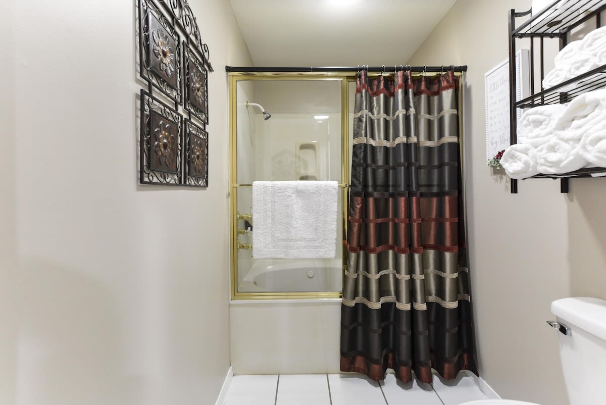 Shower tub combo in primary bedroom