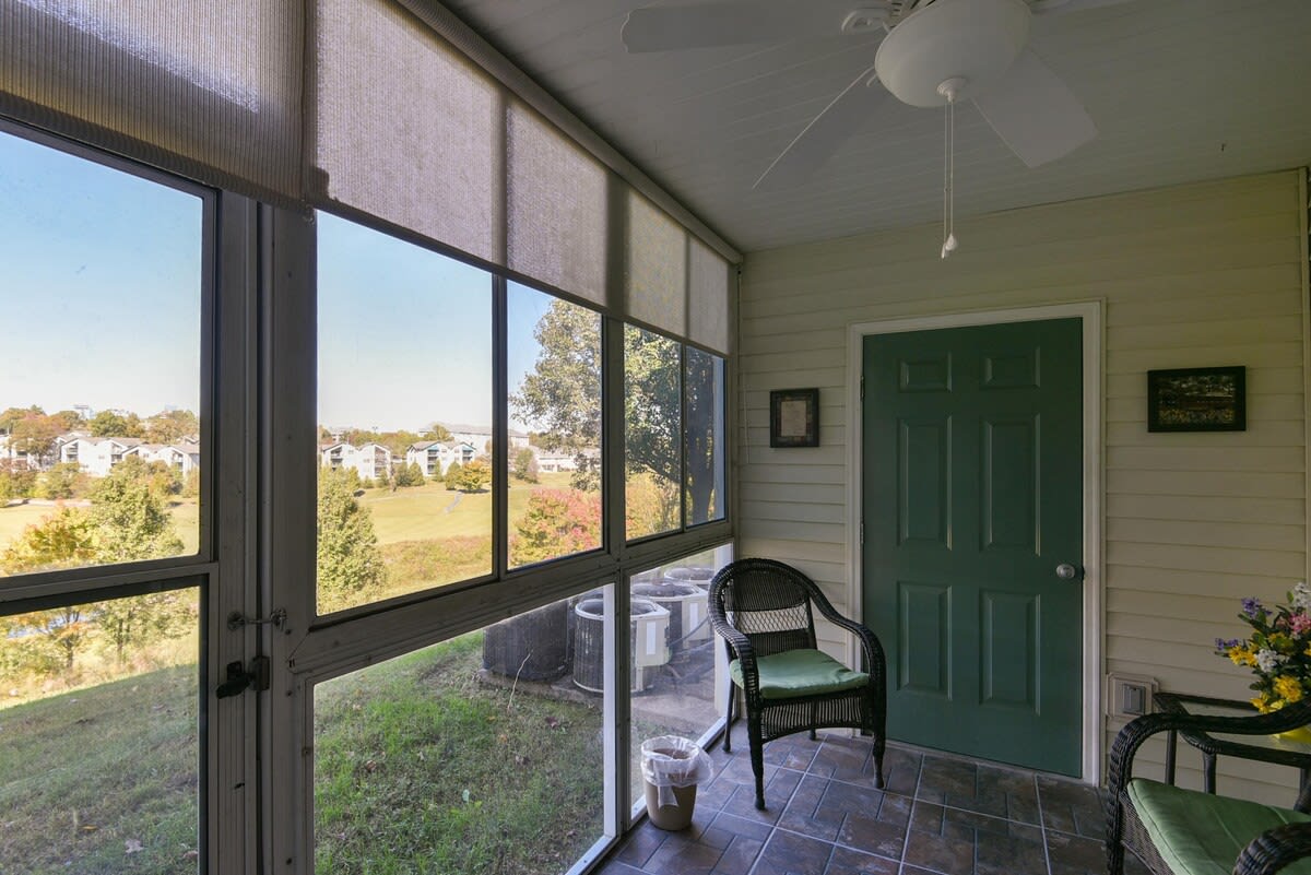 Enclosed patio, with grassy area and community charcoal grills nearby