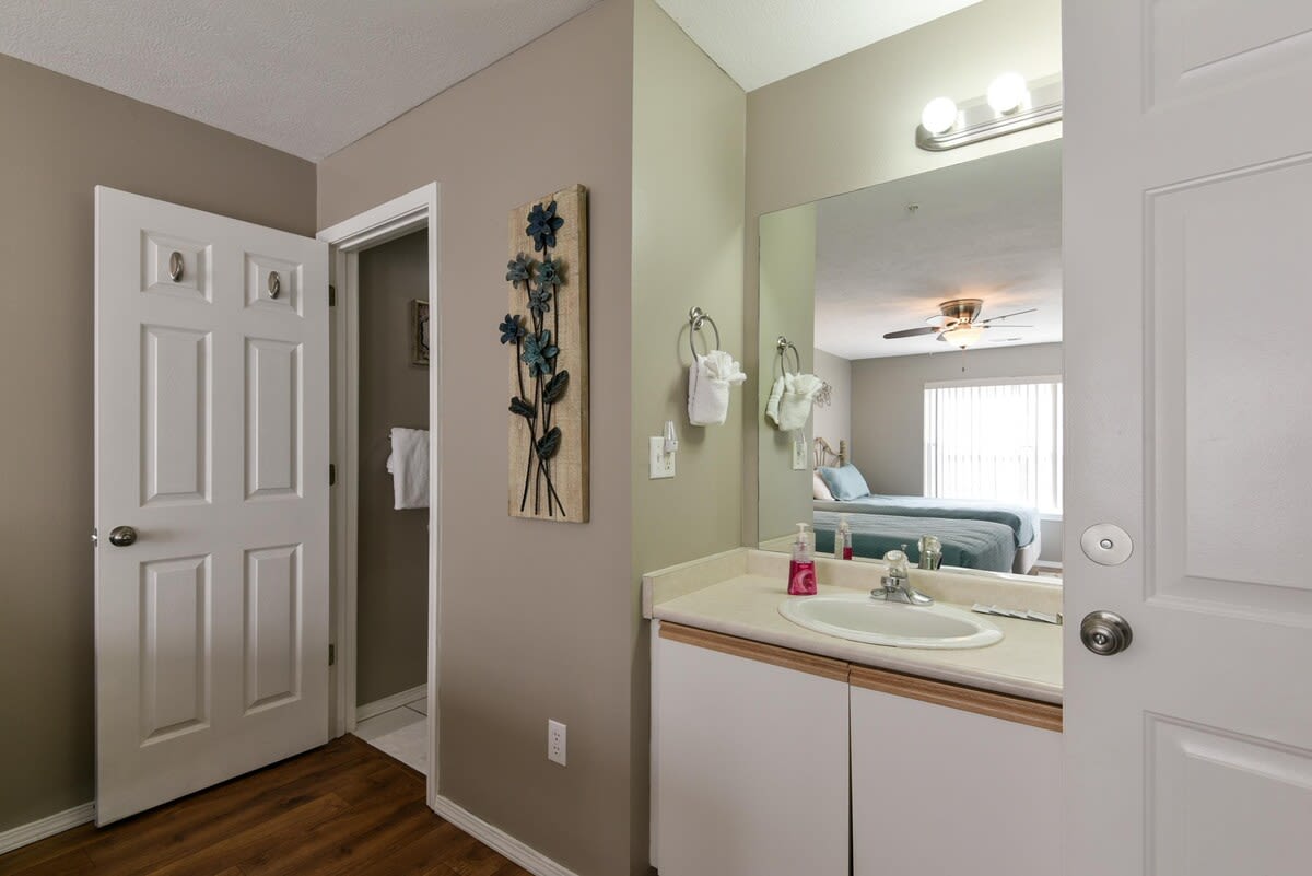 Vanity and attached bathroom in double Queen room.