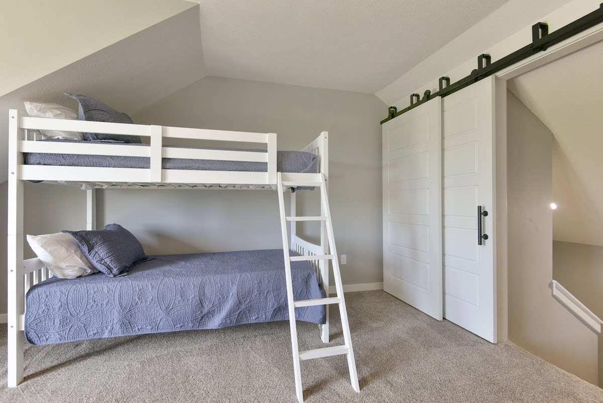 This room has the bunk beds and a queen and full beds