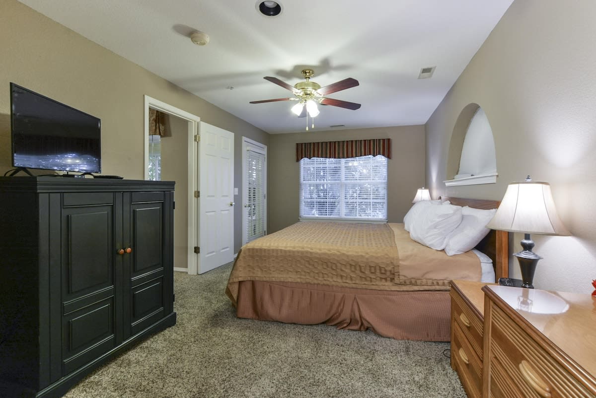 Primary bedroom w walkout access to the back porch.