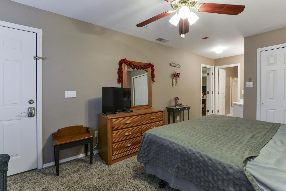 Guest bedroom with walkout access to the front porch as well as it's own bathroom.