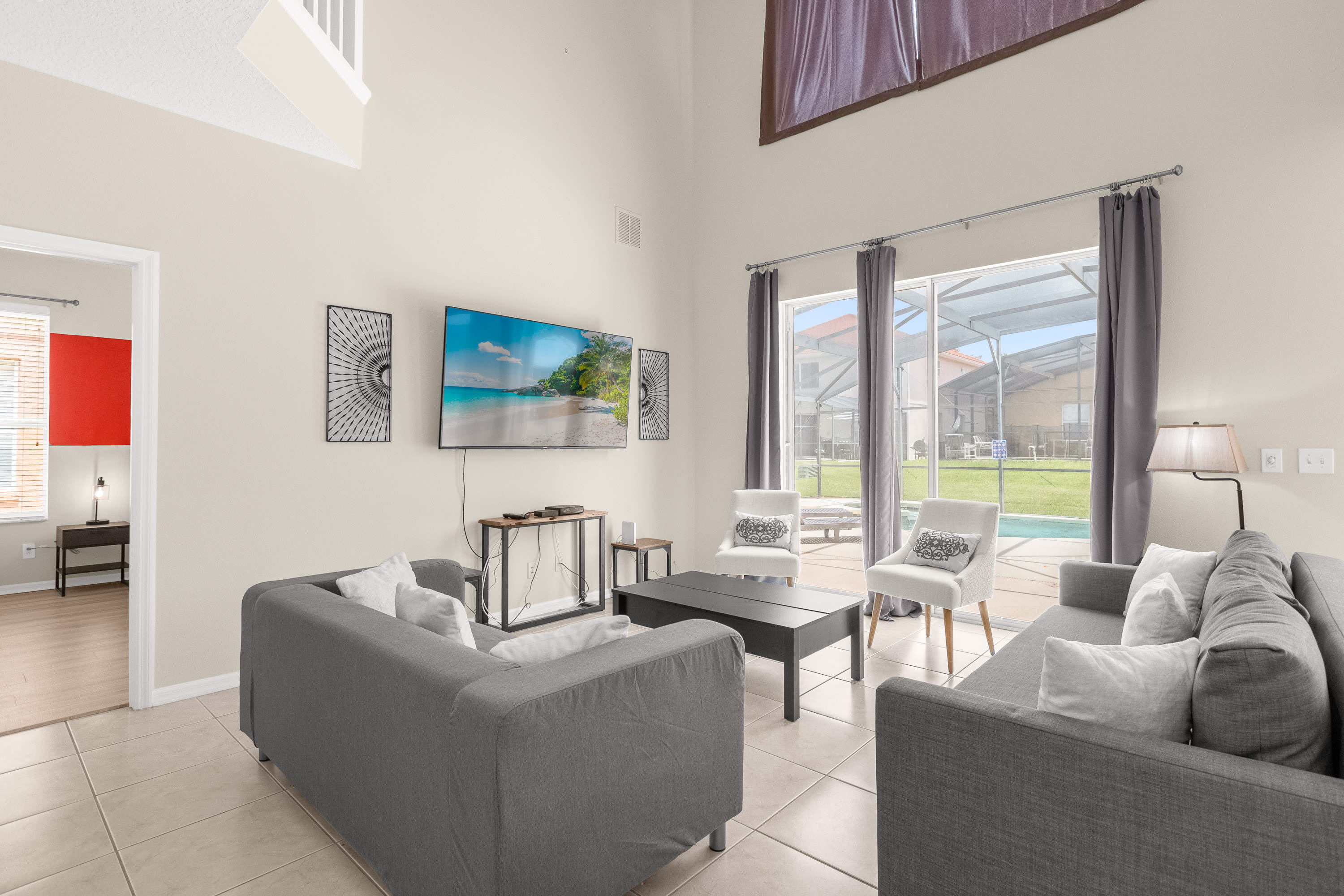 Elegant Living Room With High Ceilings And Scenic Outdoor Views