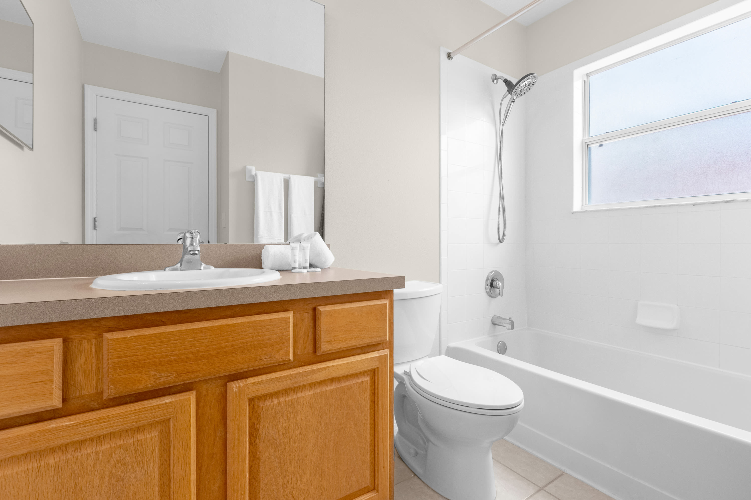 Spacious Bathroom Featuring Elegant Fixtures And Ample Lighting