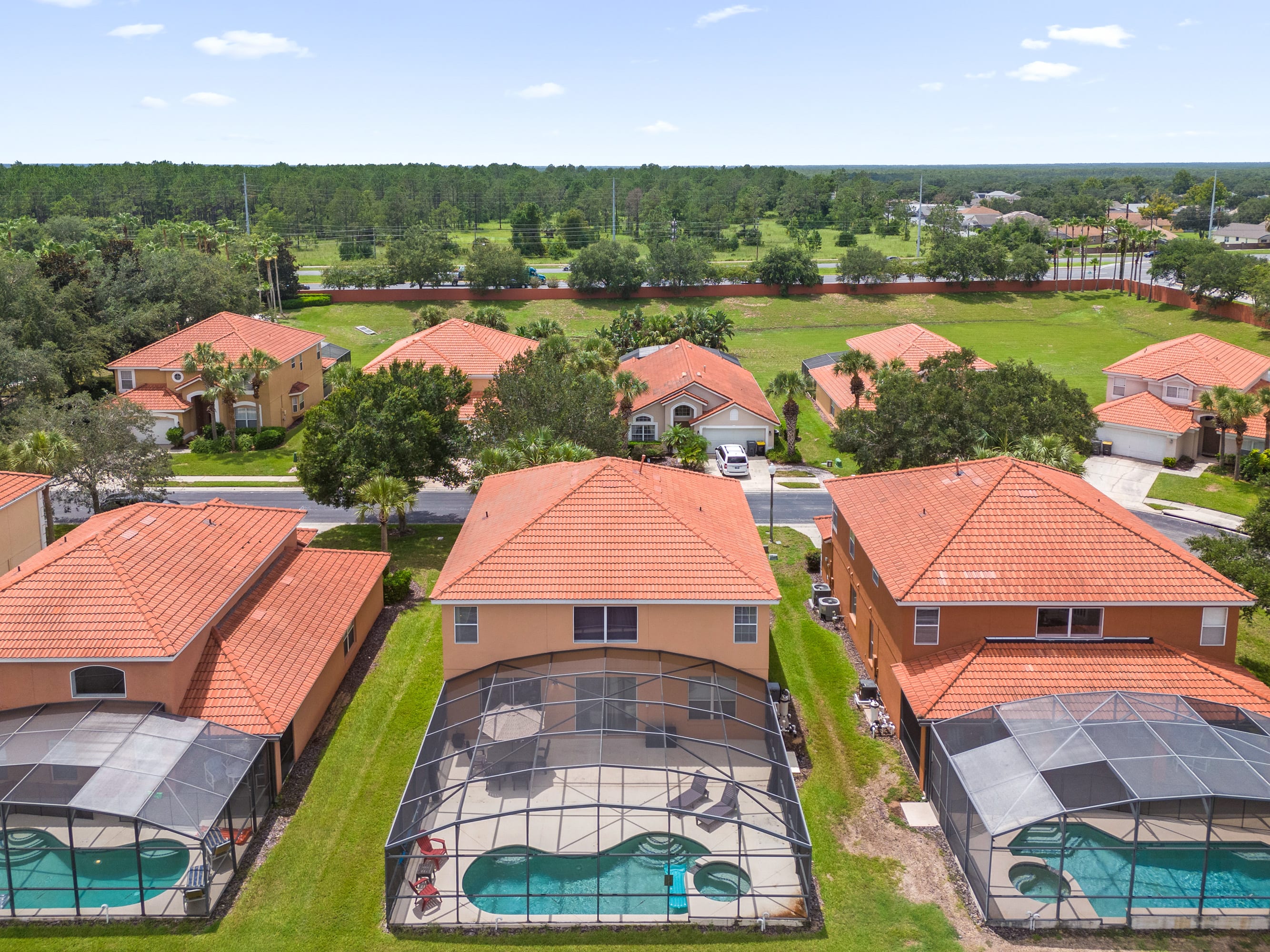Aerial View Showcasing Stunning Homes With Private Pools And Lush Greenery