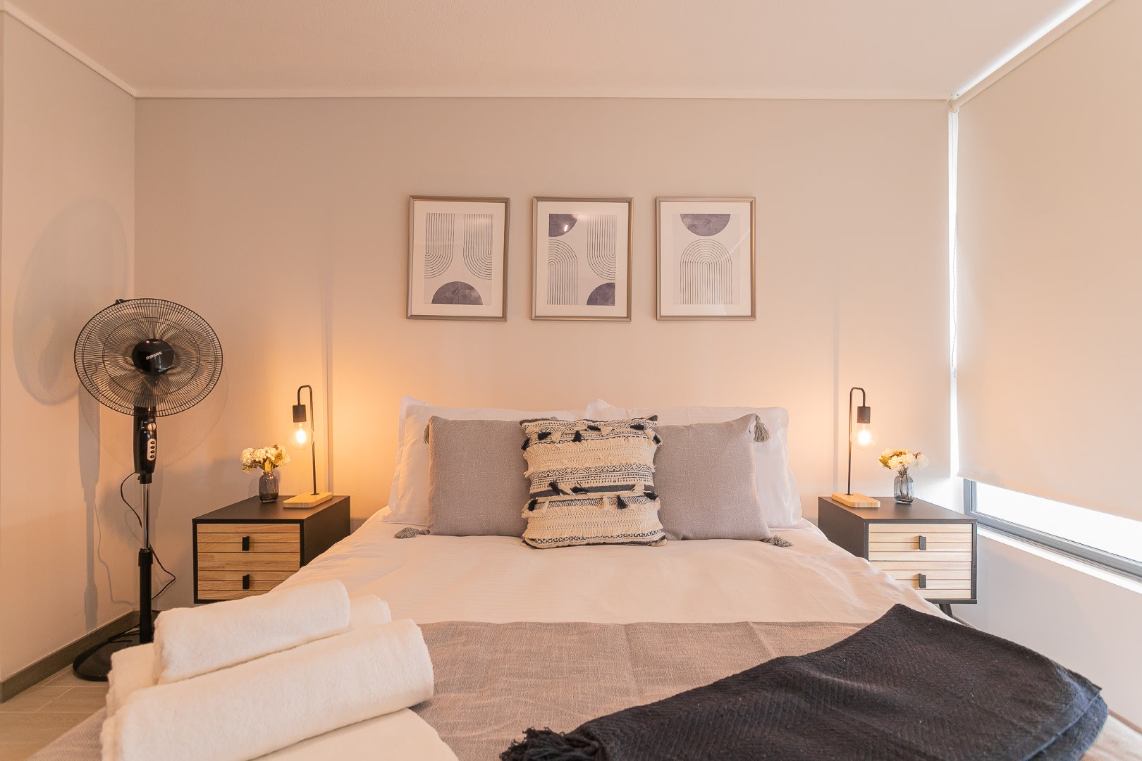 Unwind in this stylish studio bedroom with cozy bedding and ambient lighting, perfect for a restful escape in Chile.