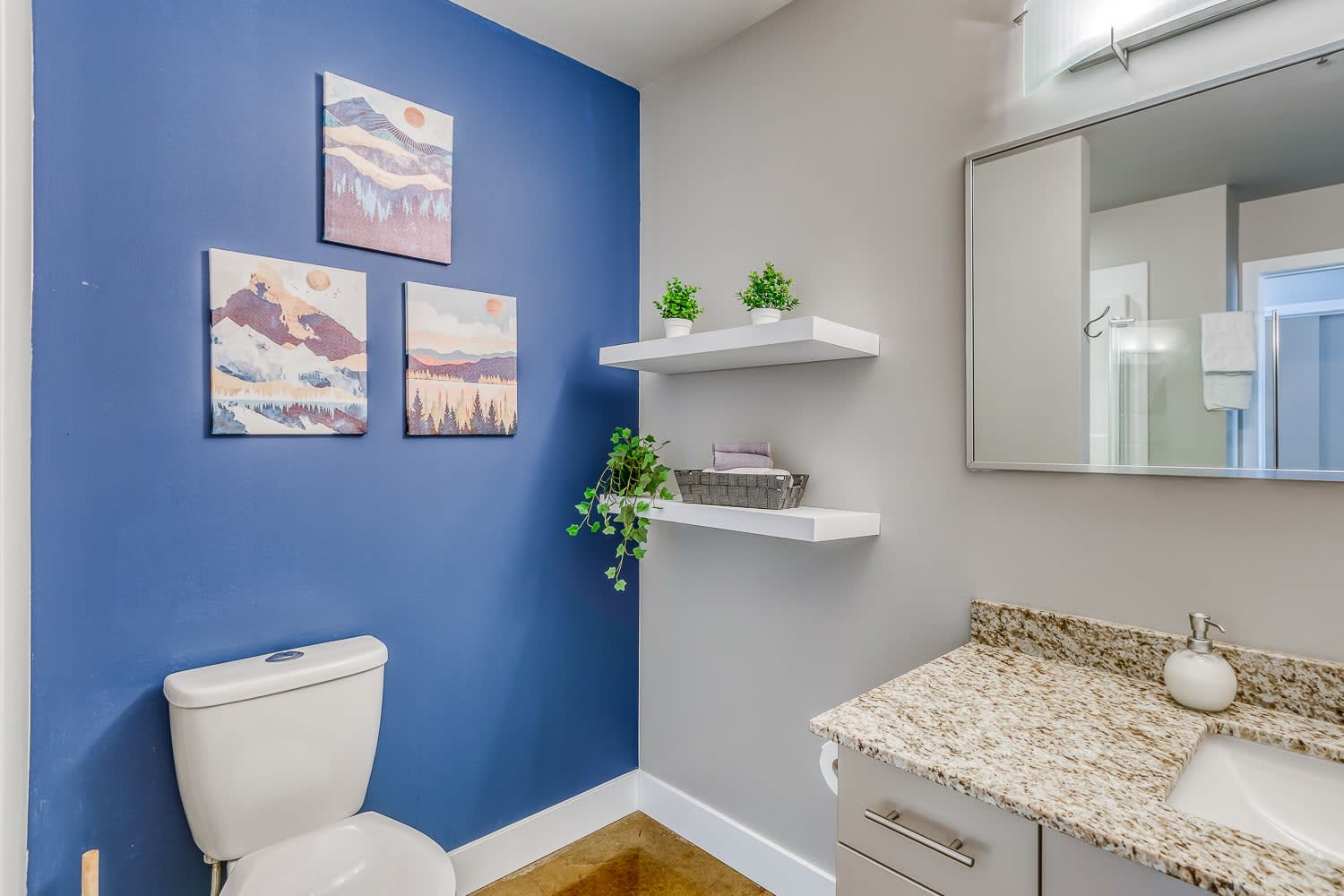 Stylish Bathroom With Vibrant Blue Accent Wall.