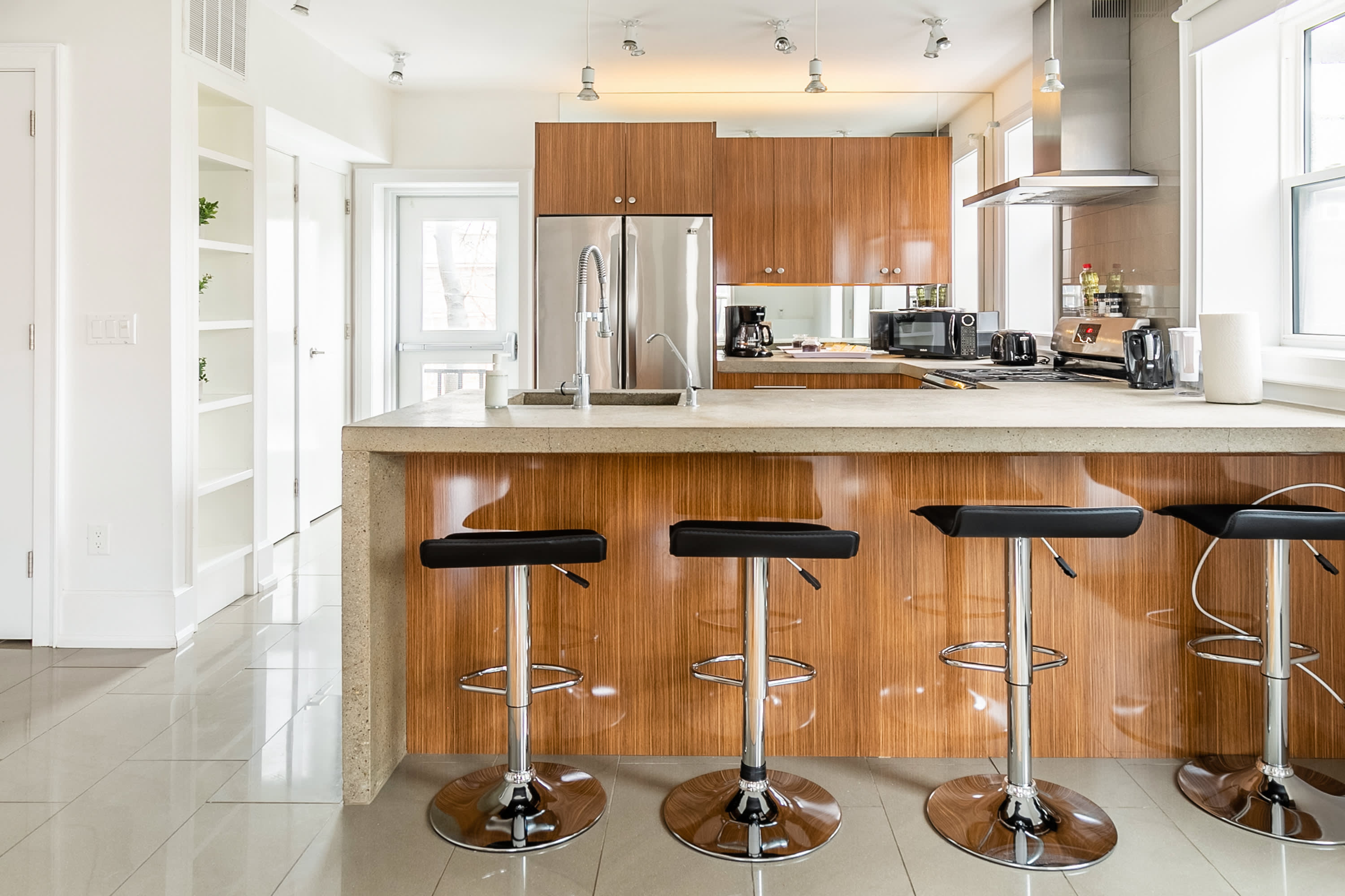 Stylish Kitchen With Sleek Appliances And Breakfast Bar For Four