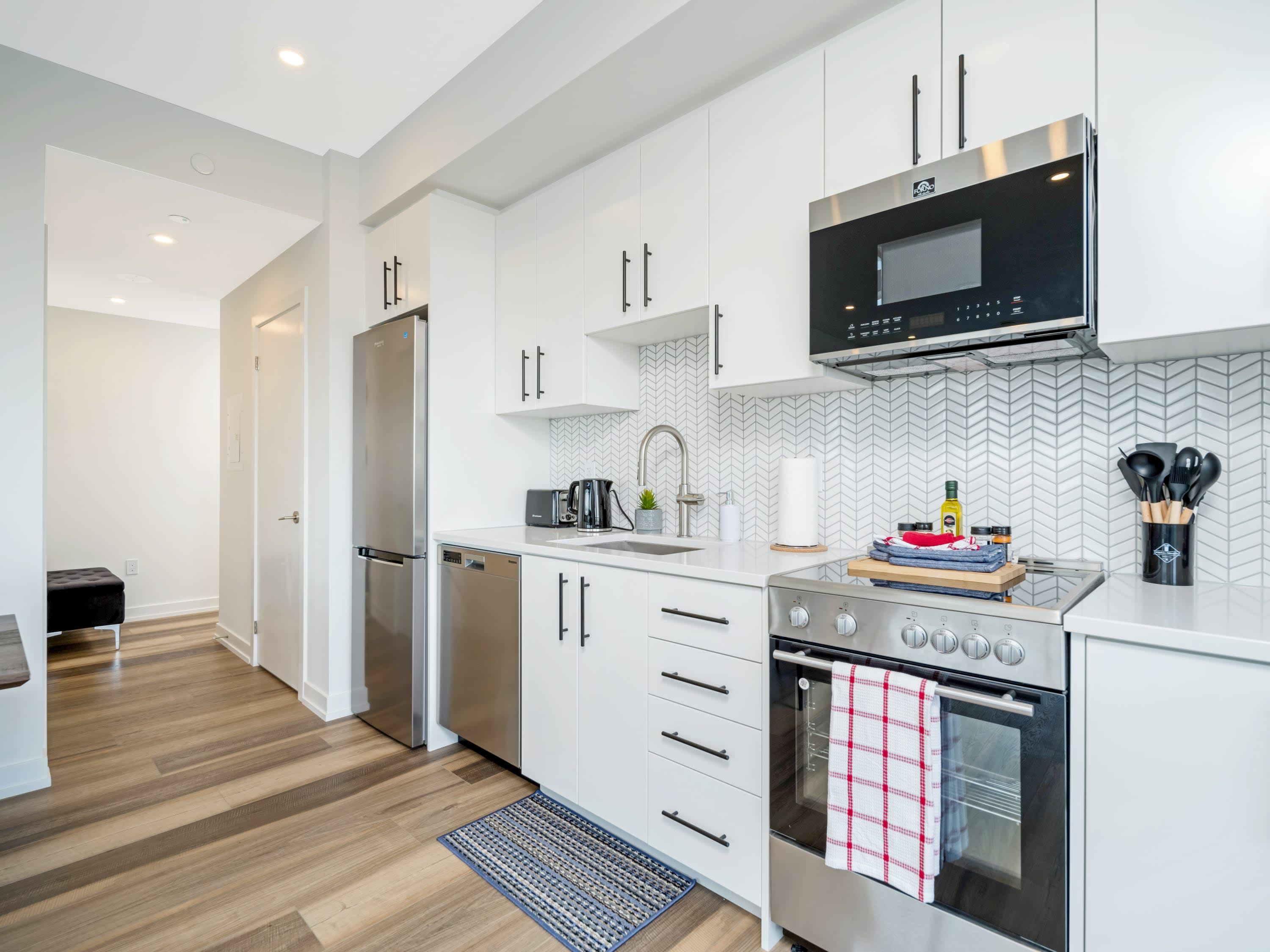 Modern Kitchen Featuring Quartz Countertops And Ample Storage Space
