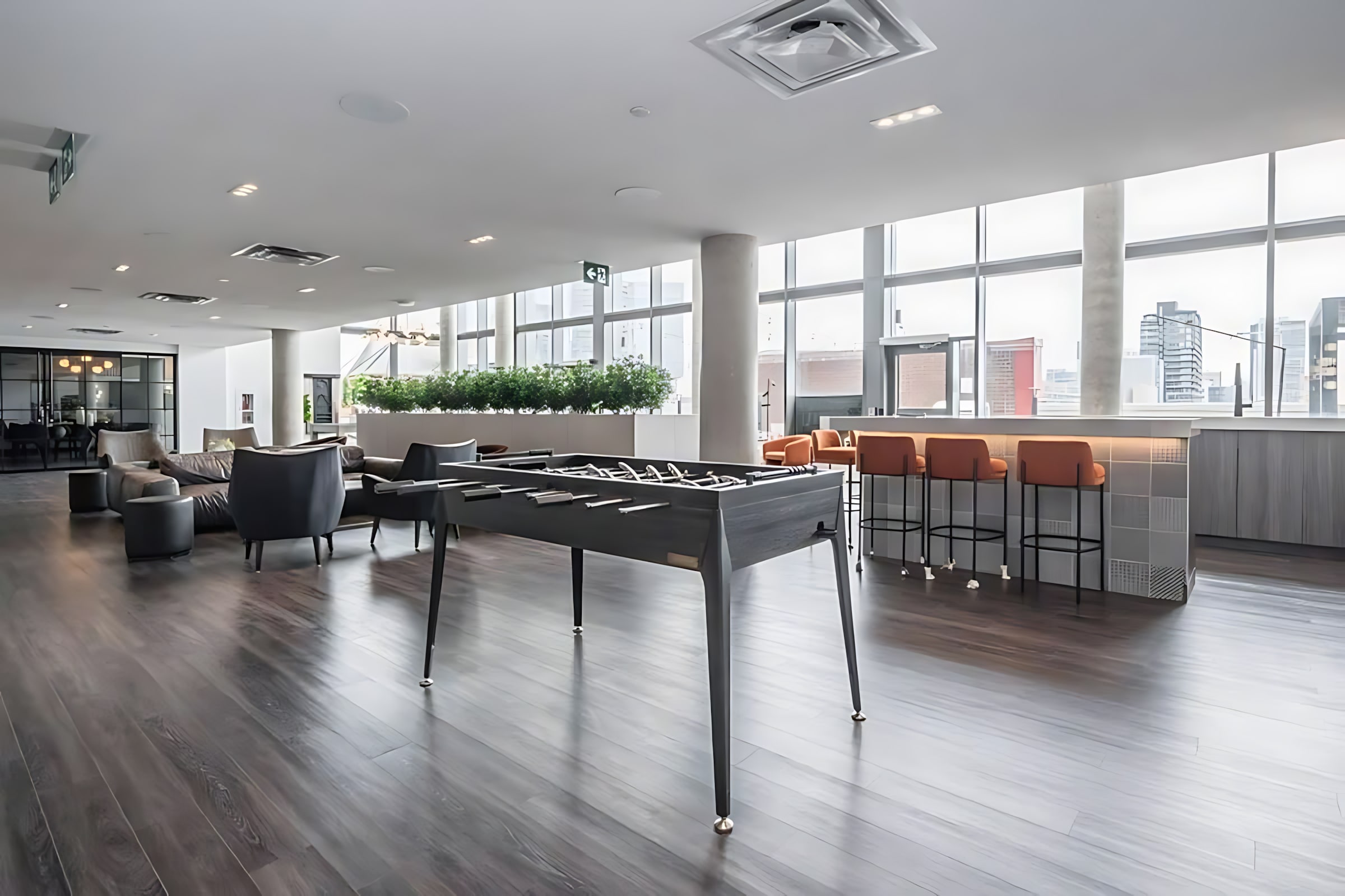 Indoor Lounge With Foosball Table And Bar Seating For Socializing
